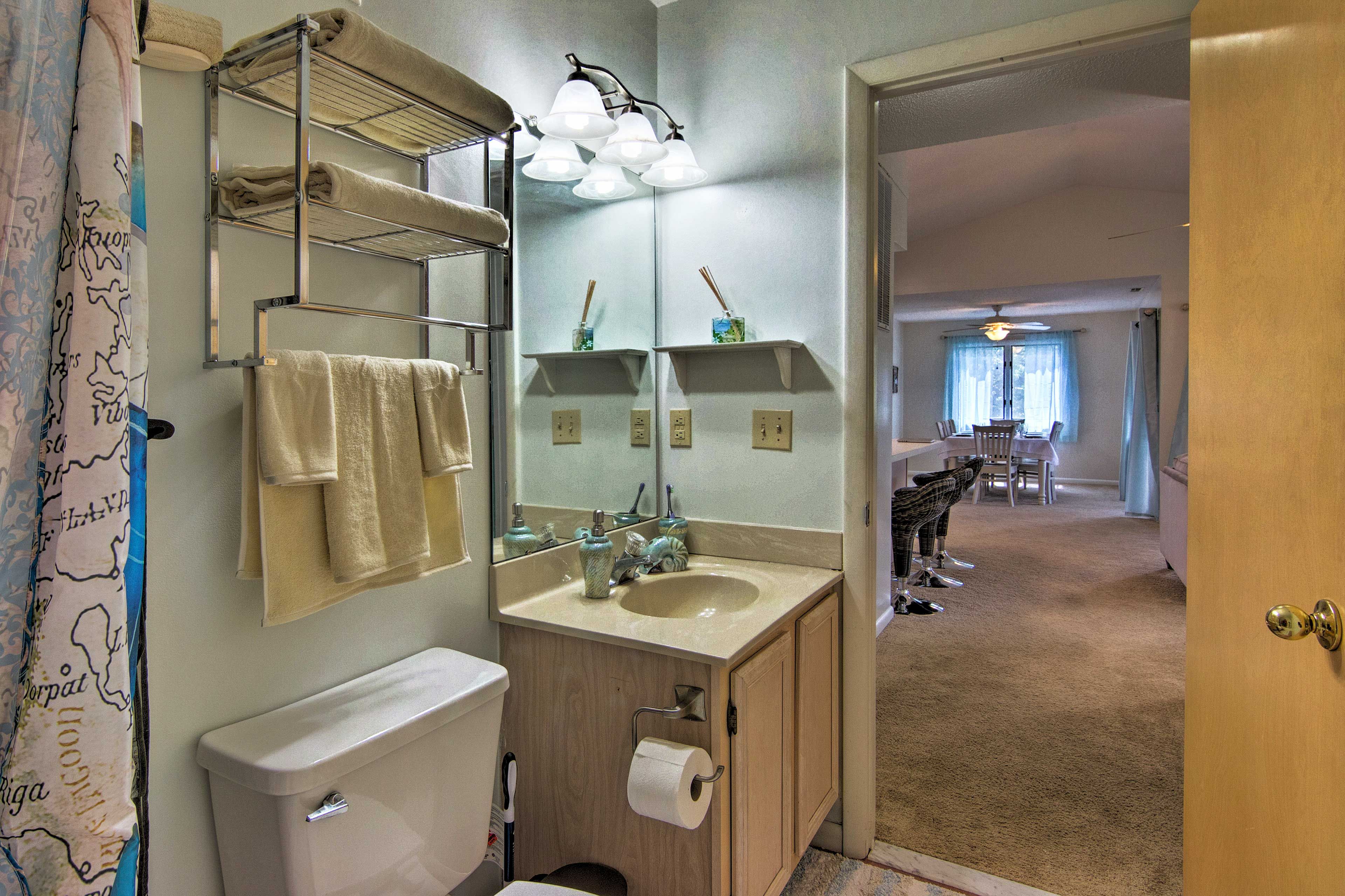 The bathroom is conveniently set steps away from the living area.