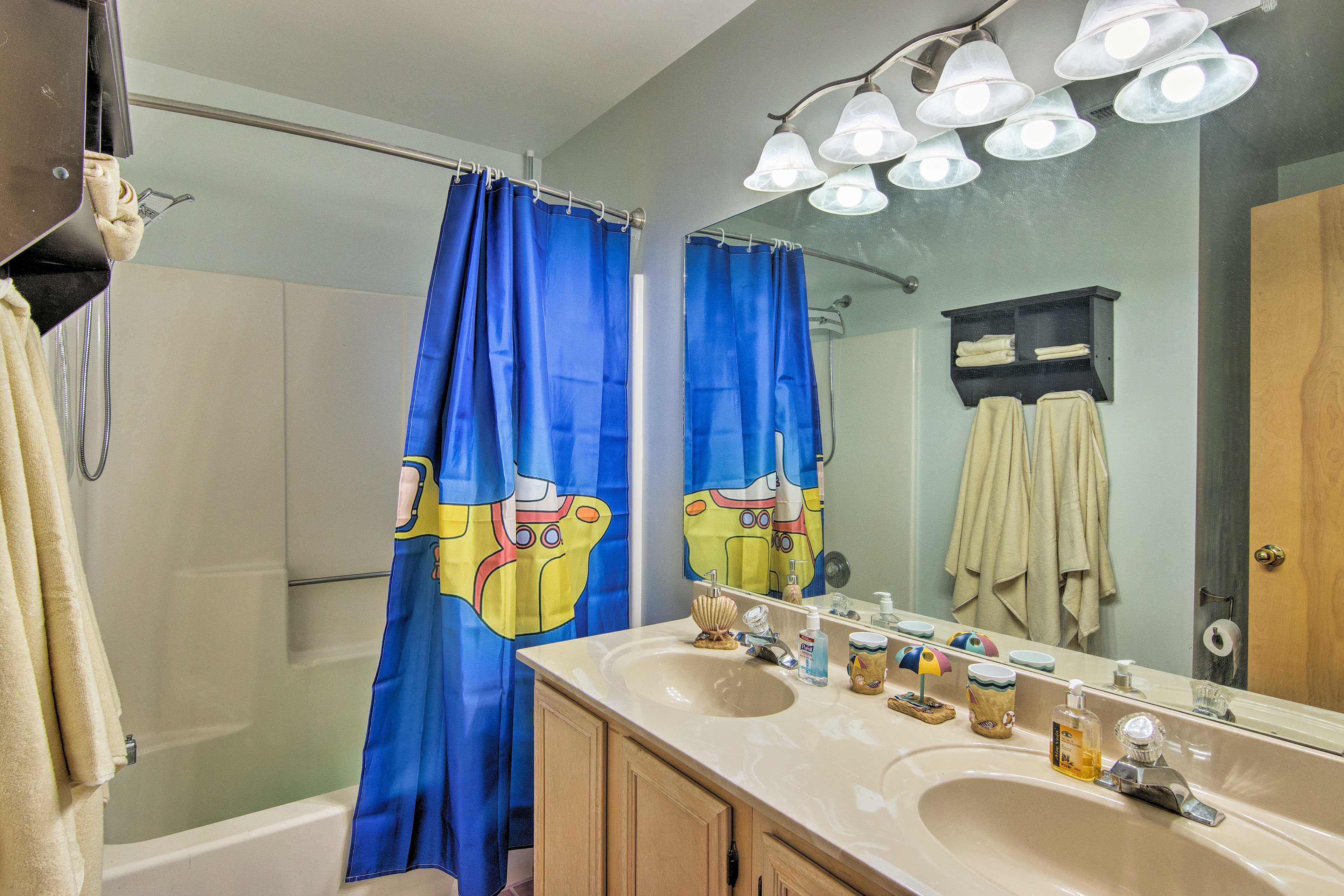 A second full bathroom features a double vanity and shower/tub combo.