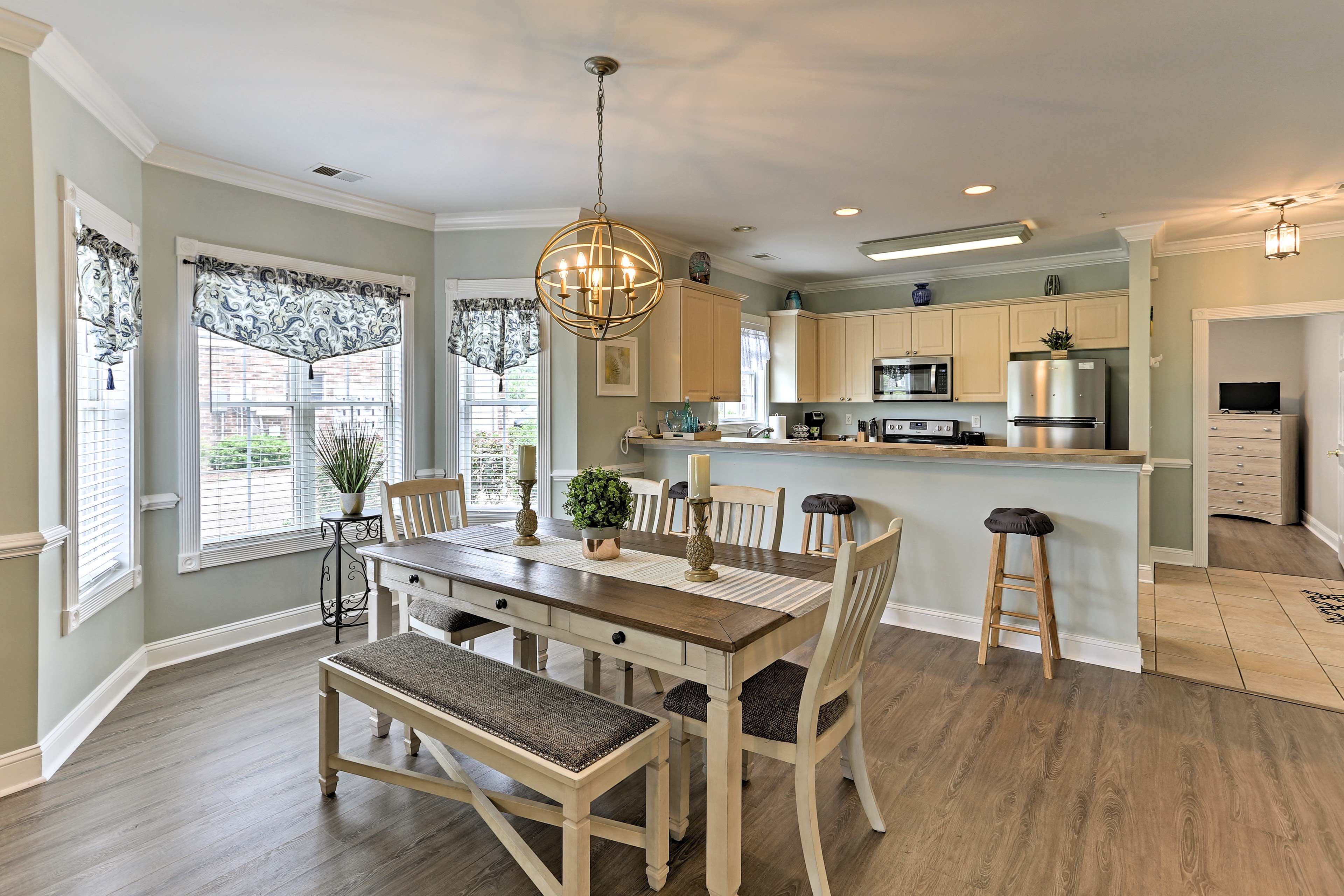 The open floor plan living area features a 6-person hardwood dining table.