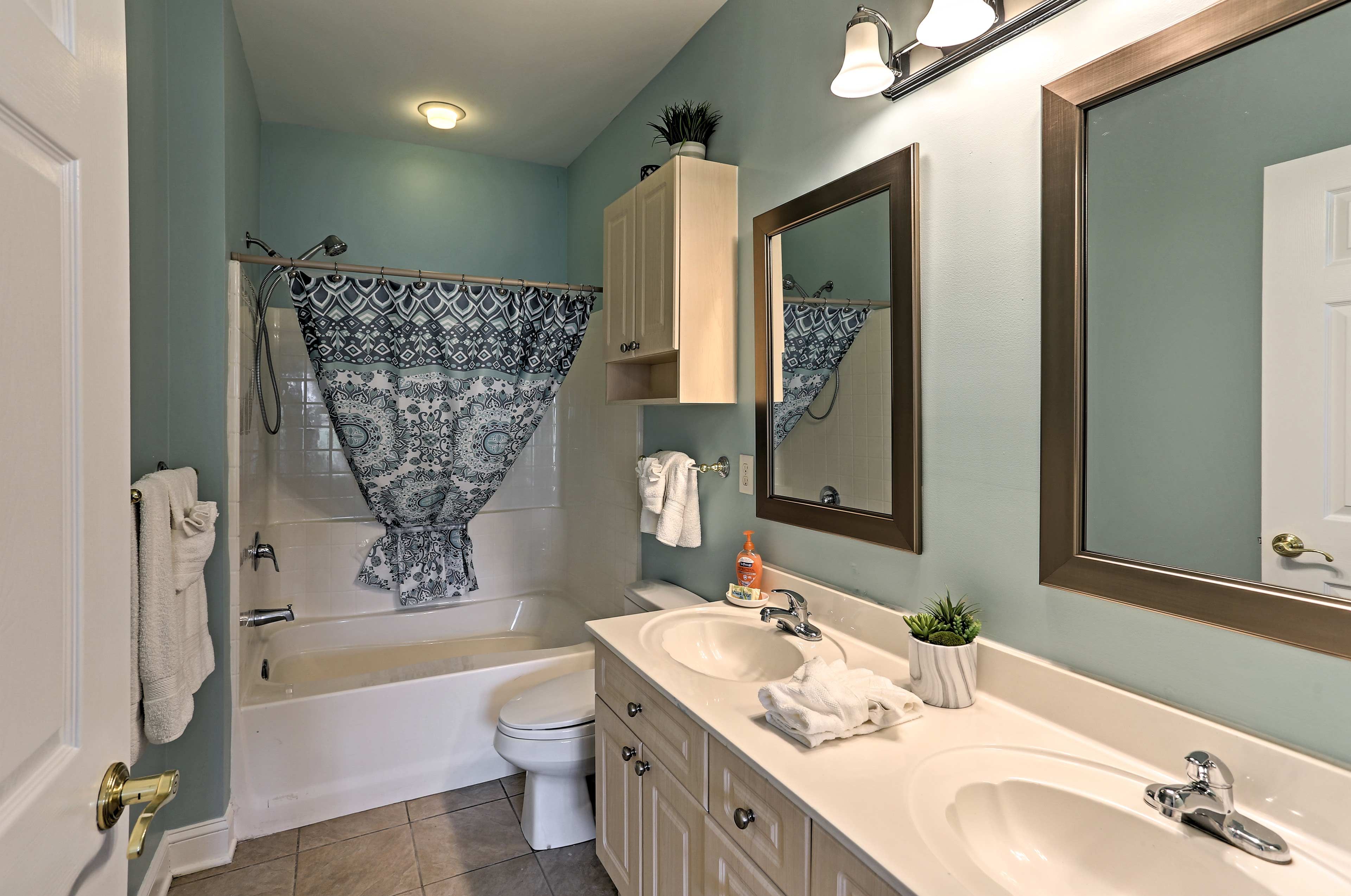 The en-suite bathroom boasts double sinks and a shower/tub combo.