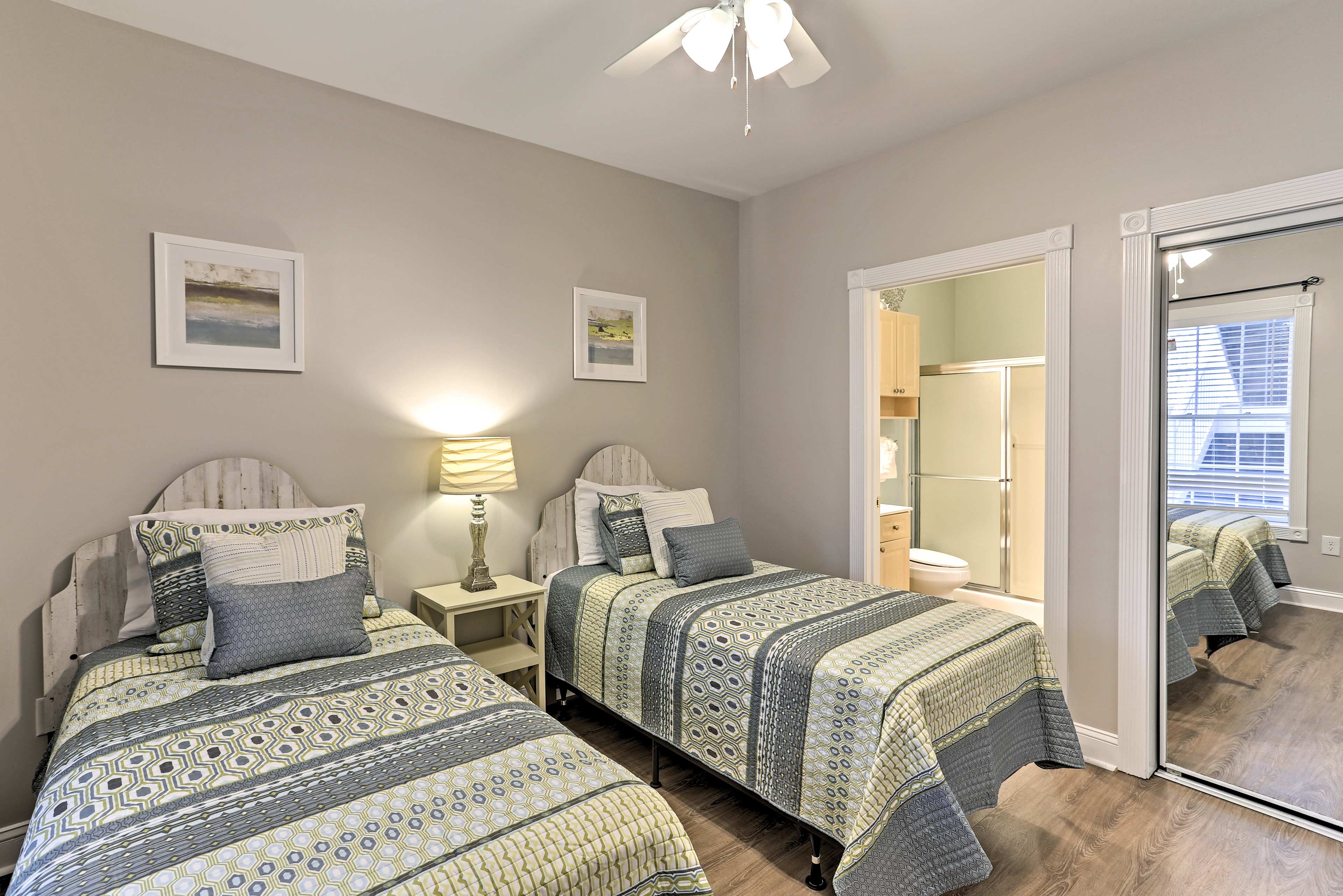 Two twin beds sit steps away from the en-suite bathroom.