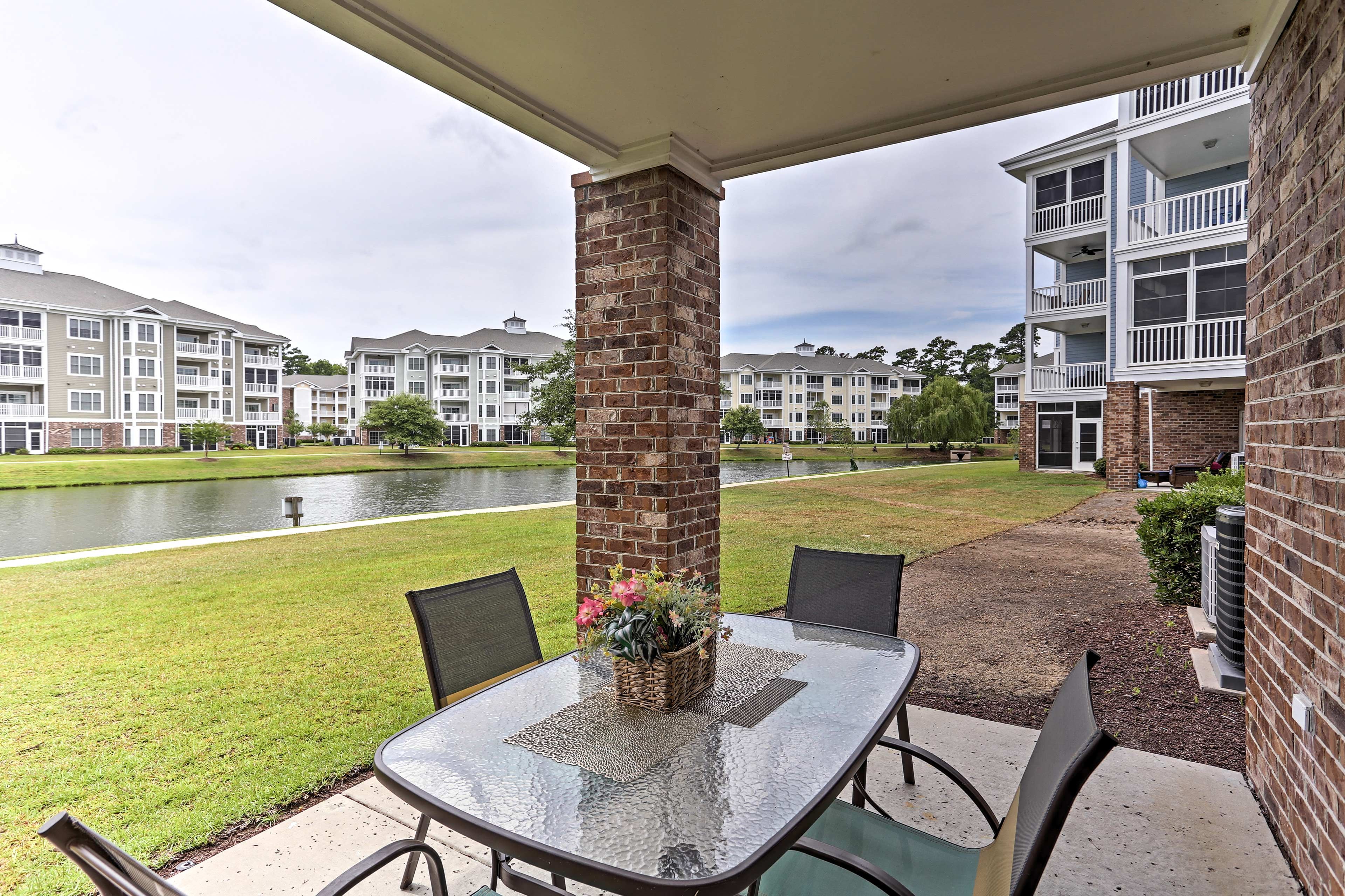 Step through the sliding glass doors to unwind at the glass dining table.