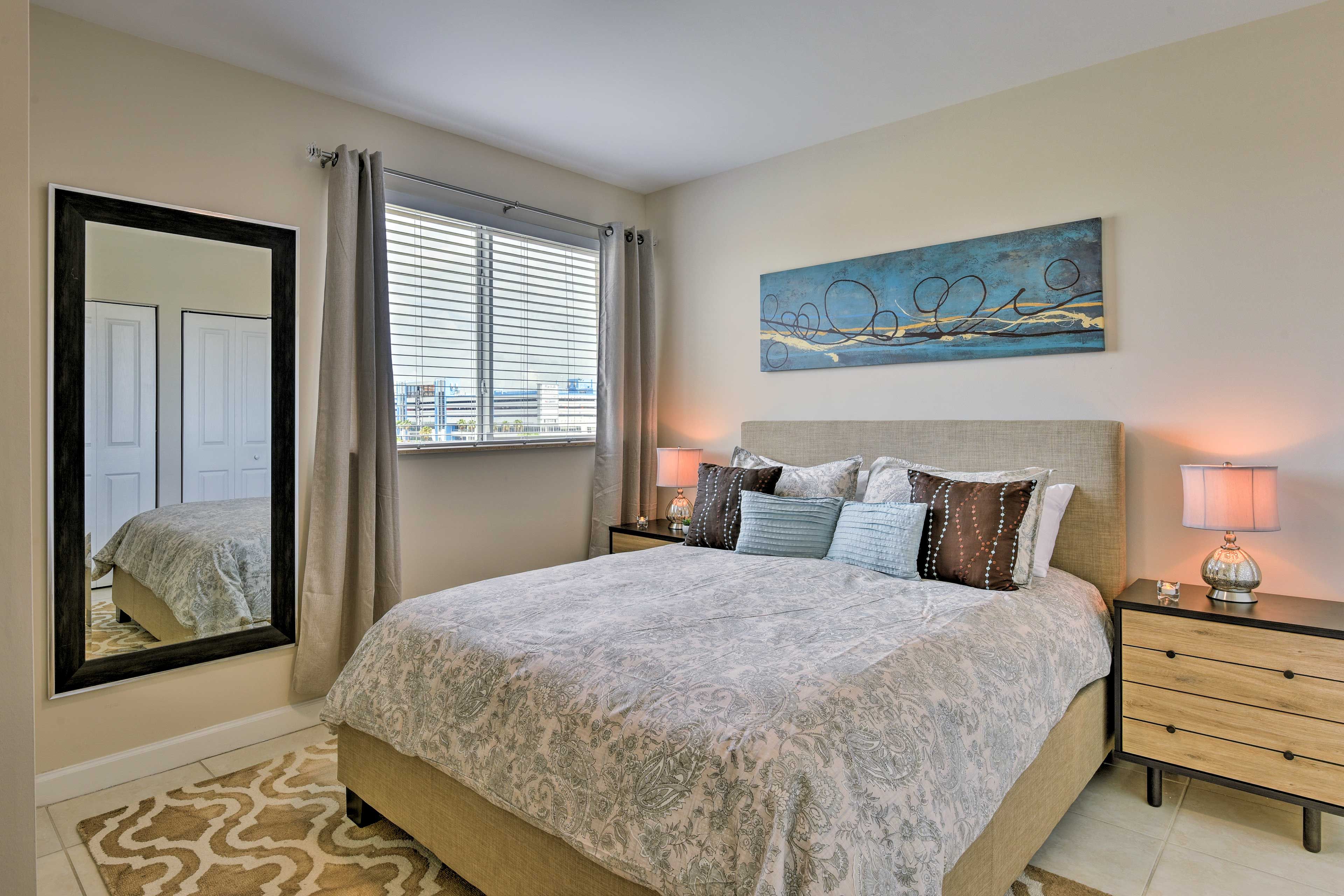 Chic furniture and beautiful artwork highlight the bedroom.