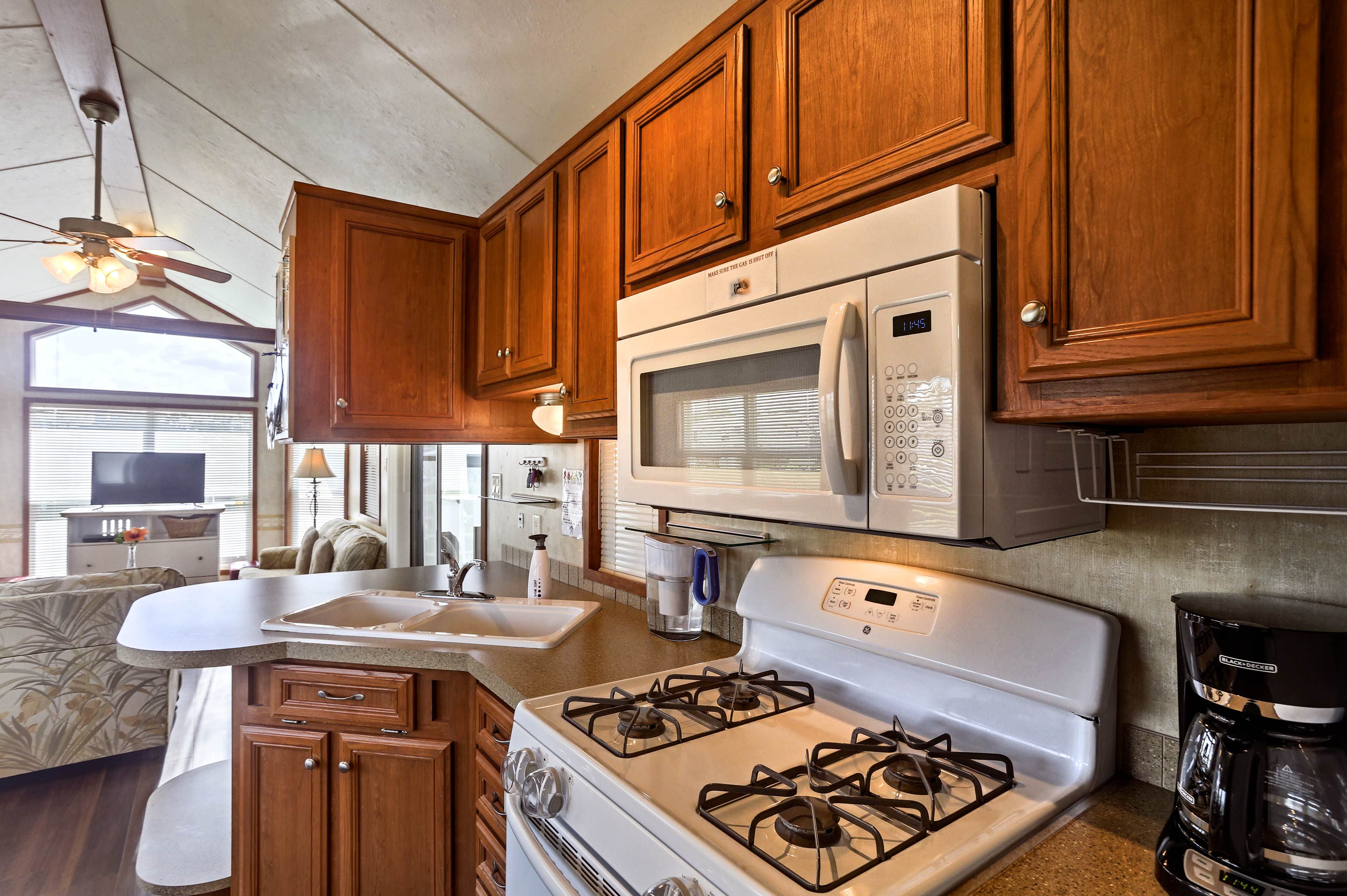 The kitchen is complete with stylish cabinetry, a coffee maker and much more!