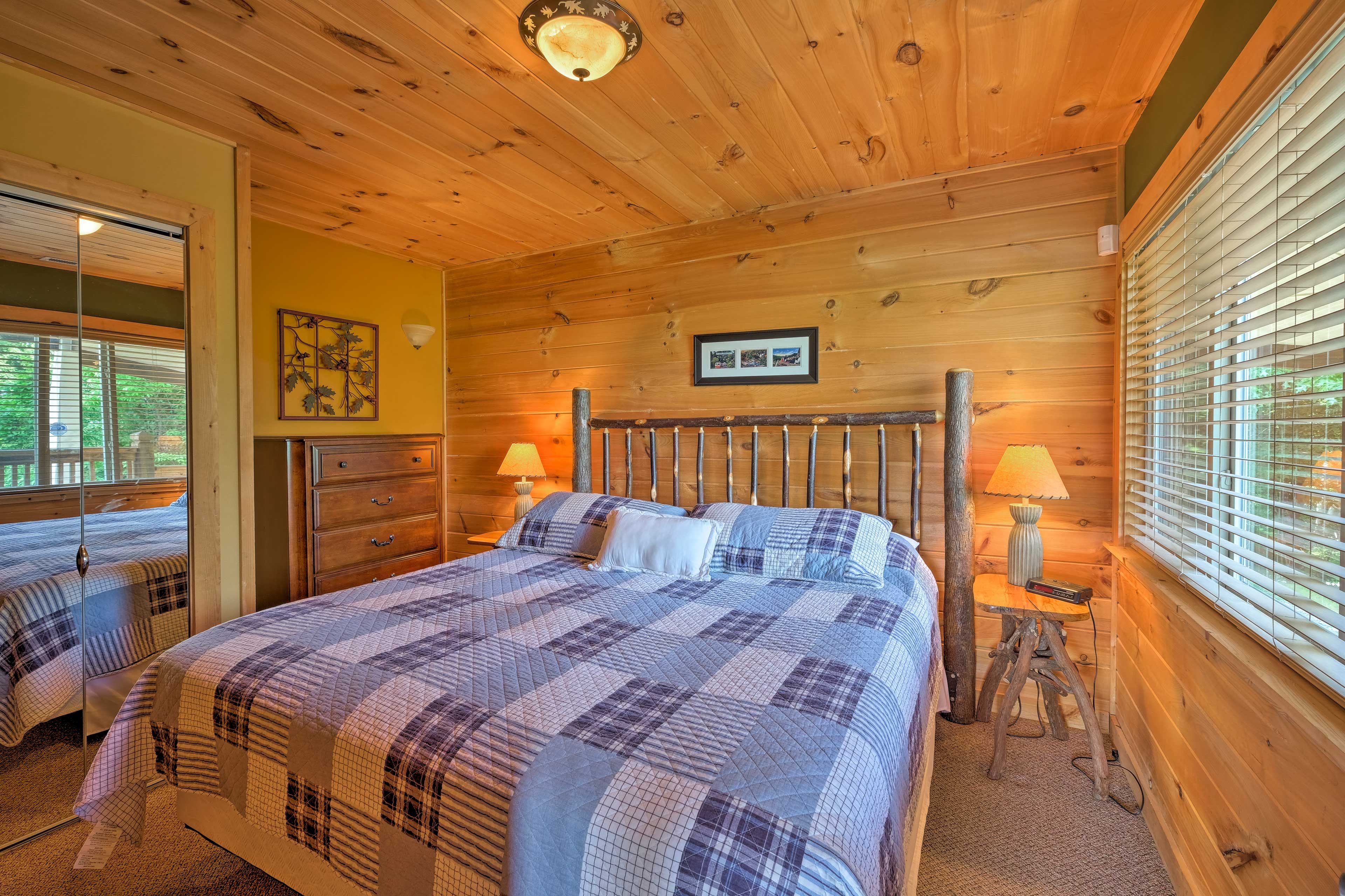 A king bed topped with a charming quilt furnishes the main bedroom.