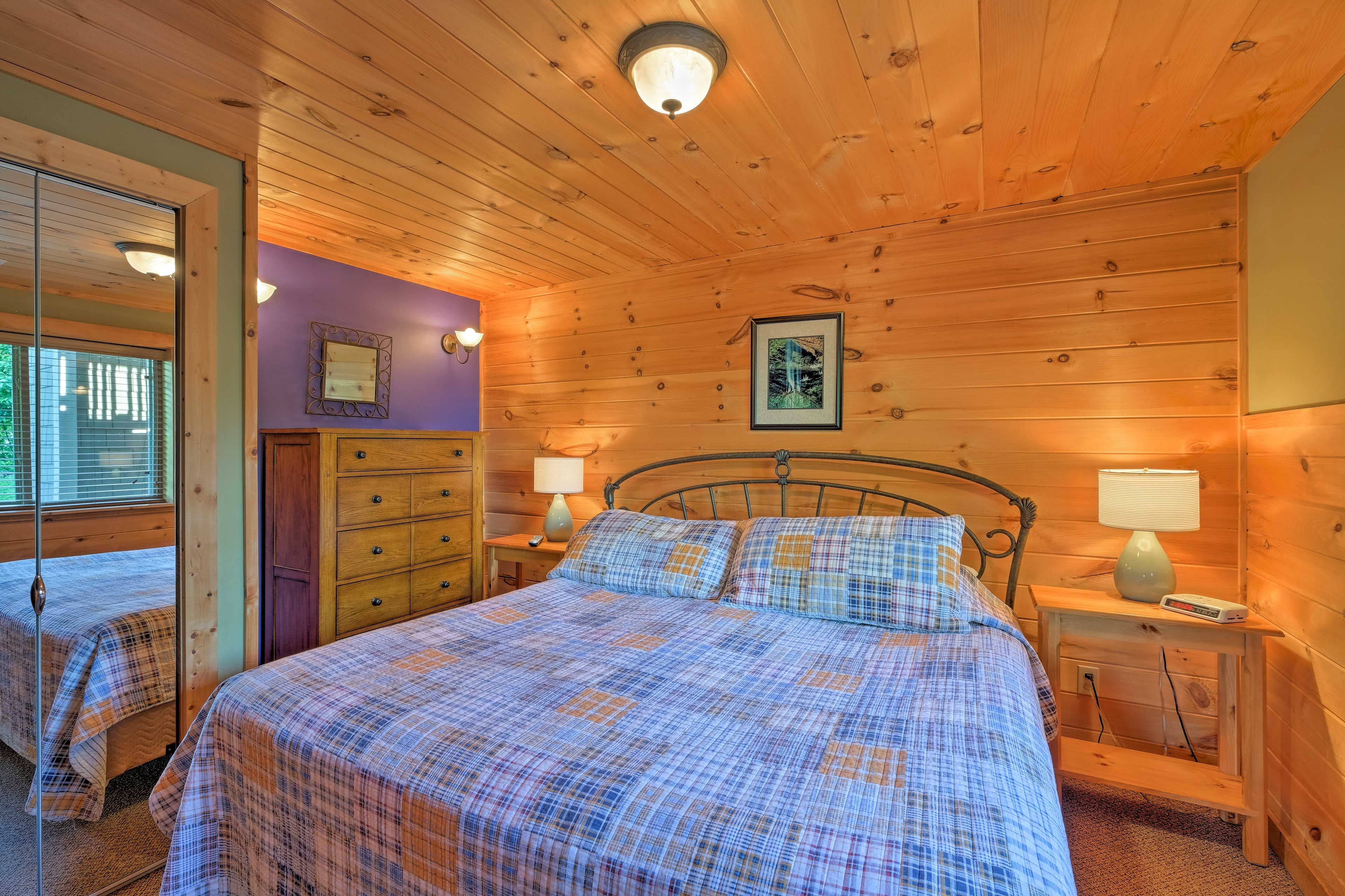 Cozy wood-paneled walls and colorful accents decorate this sleeping space.