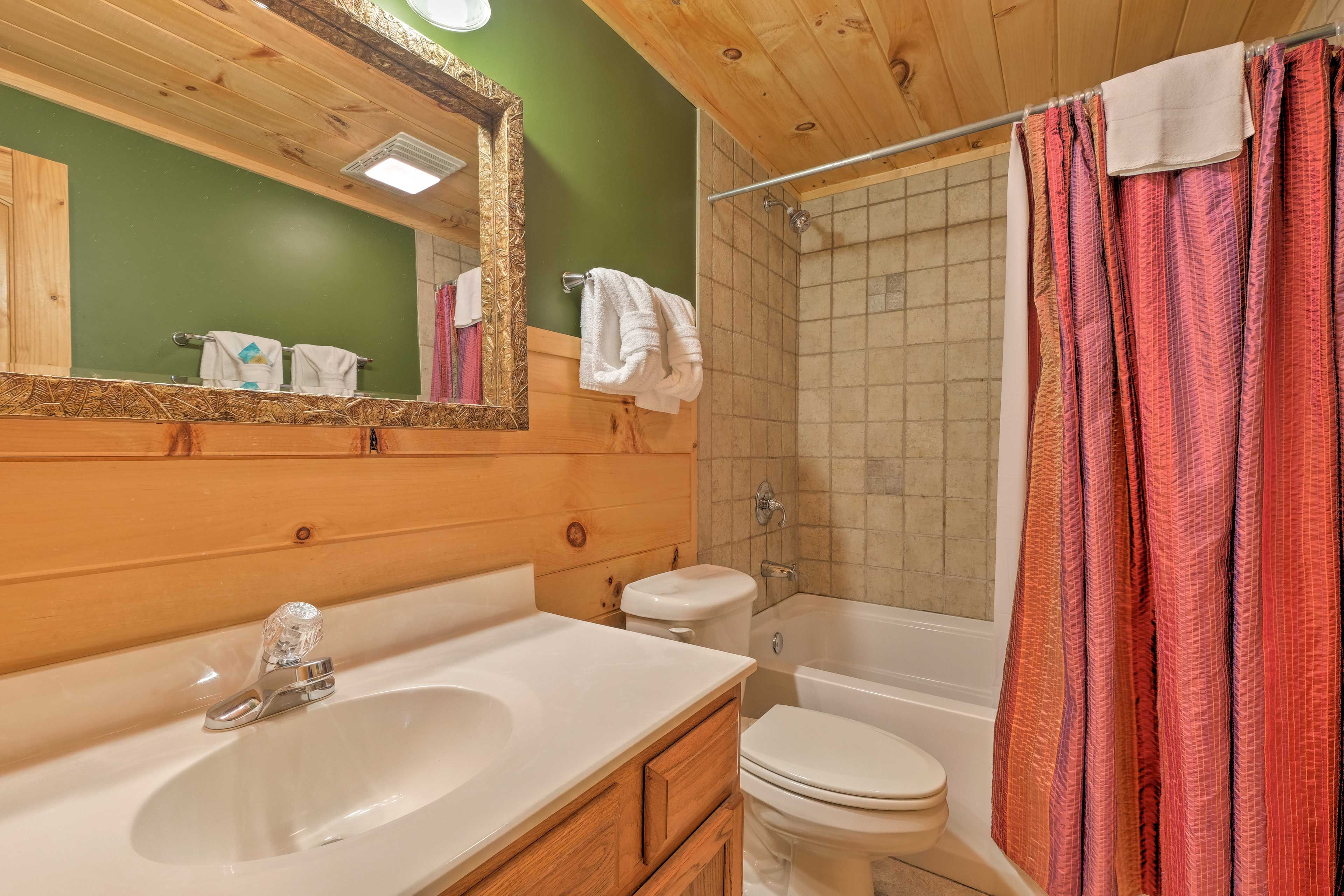 Tiled accents furnish the shower/tub combo of the third full bathroom.