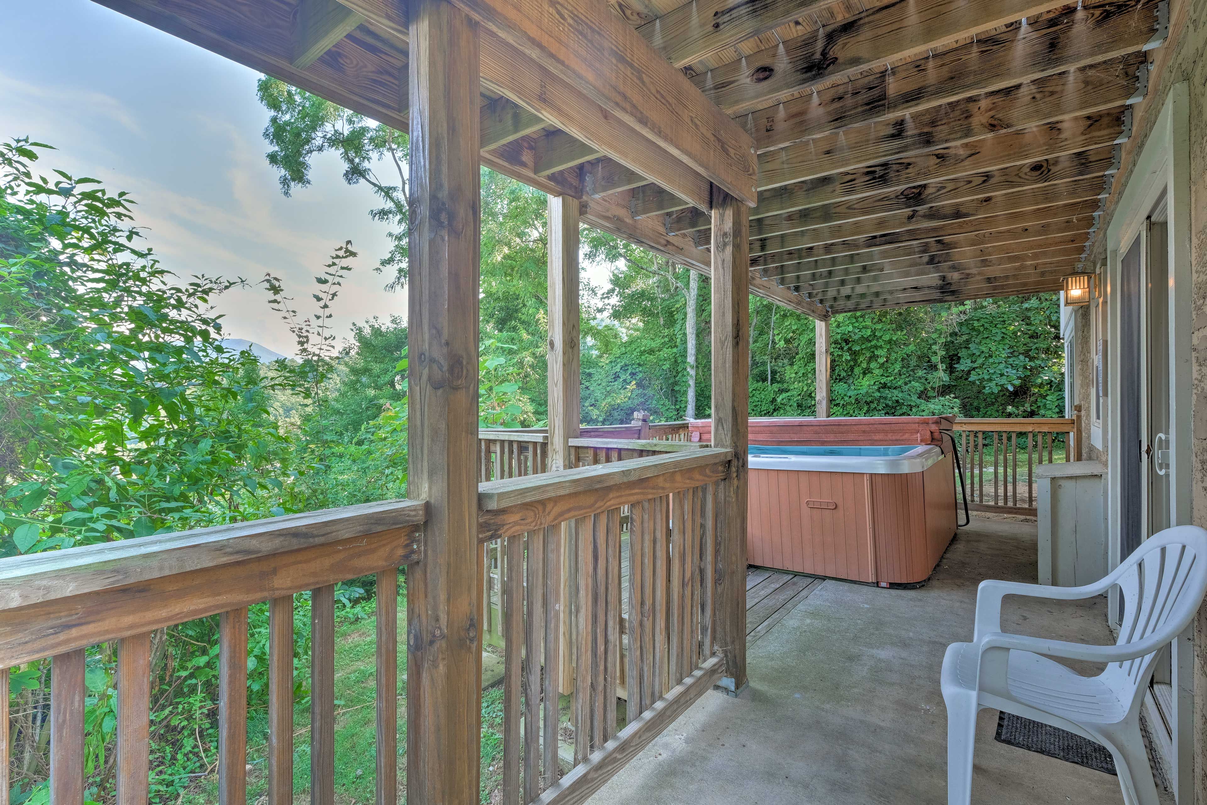 Sliding glass doors open to the covered lower deck with the 6-person hot tub.