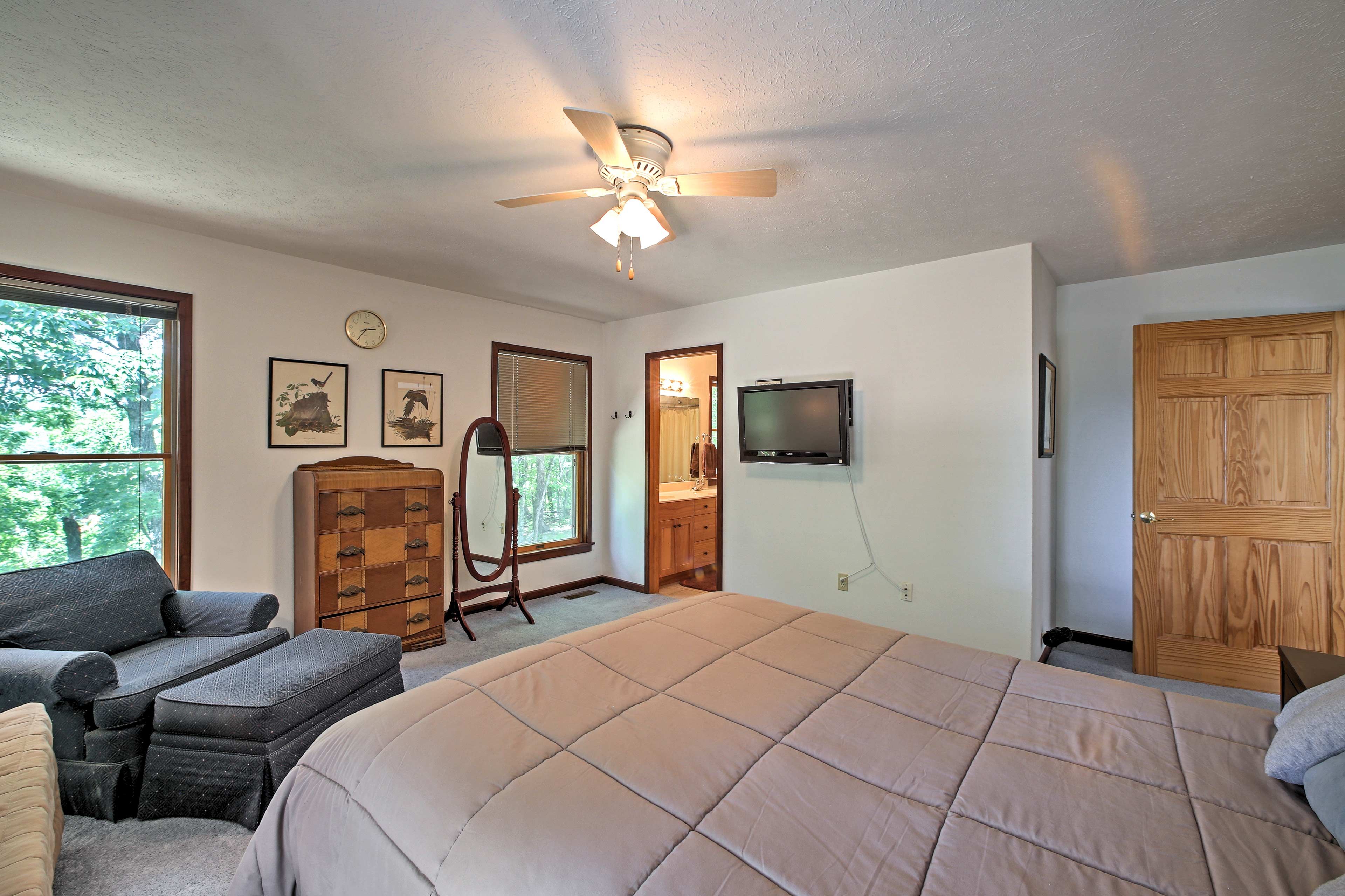 The first bedroom includes a queen bed and a flat-screen cable TV.