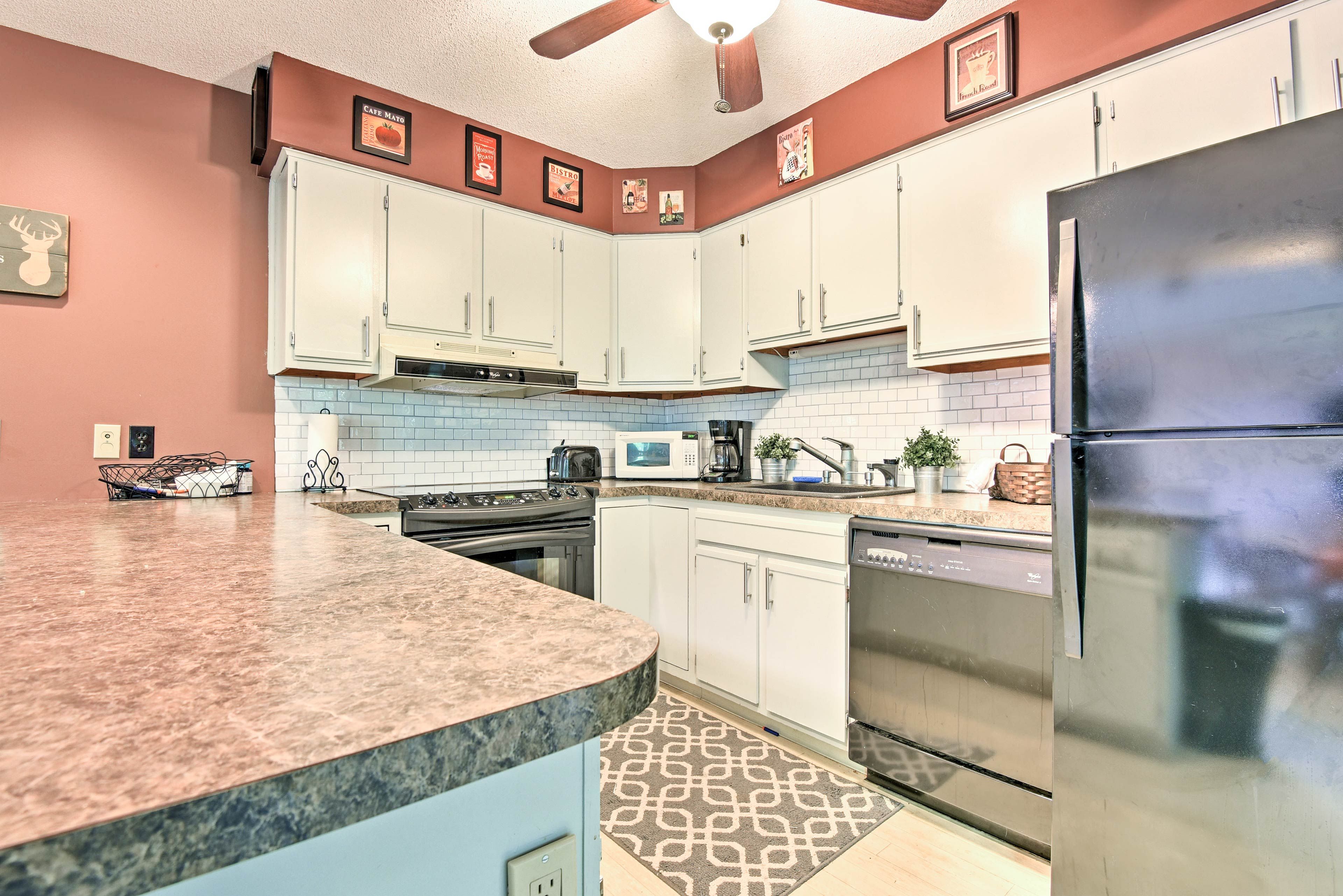 A sleek subway tile backsplash completes the fully equipped kitchen.
