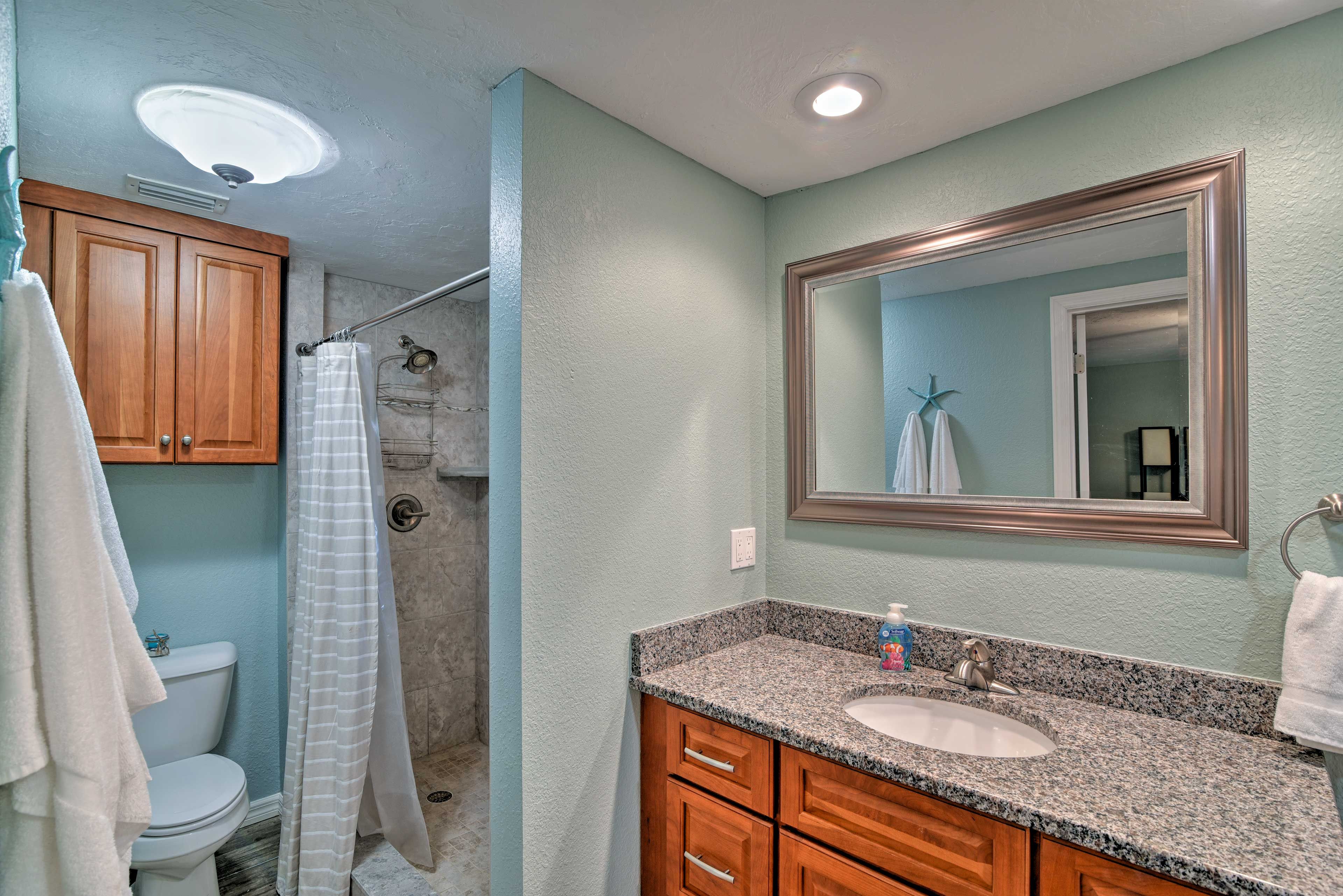 This bathroom also has a tile-lined shower.