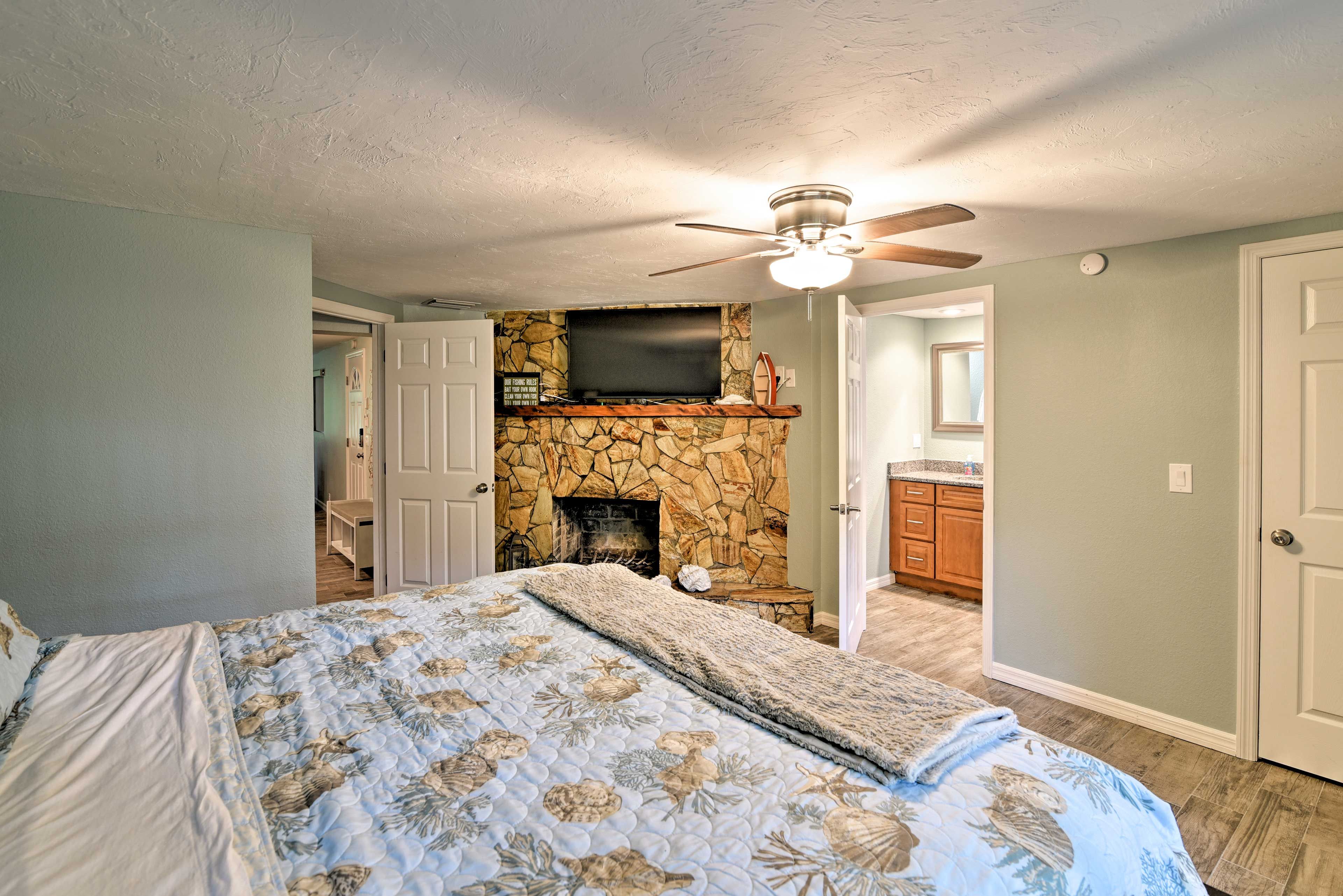 Watch the flat-screen TV above the decorative fireplace!