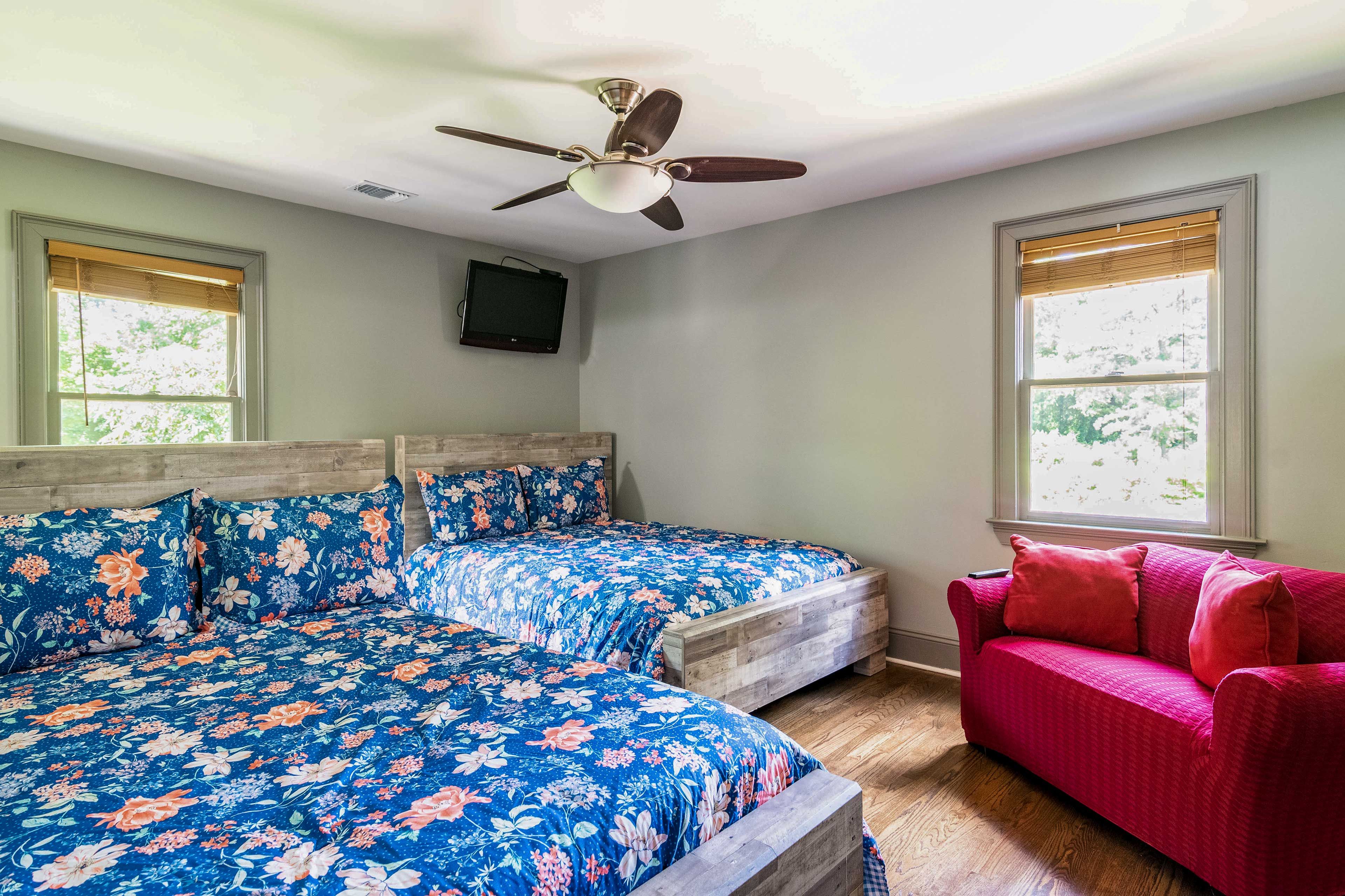 A pair of full-sized beds can be found in this room.