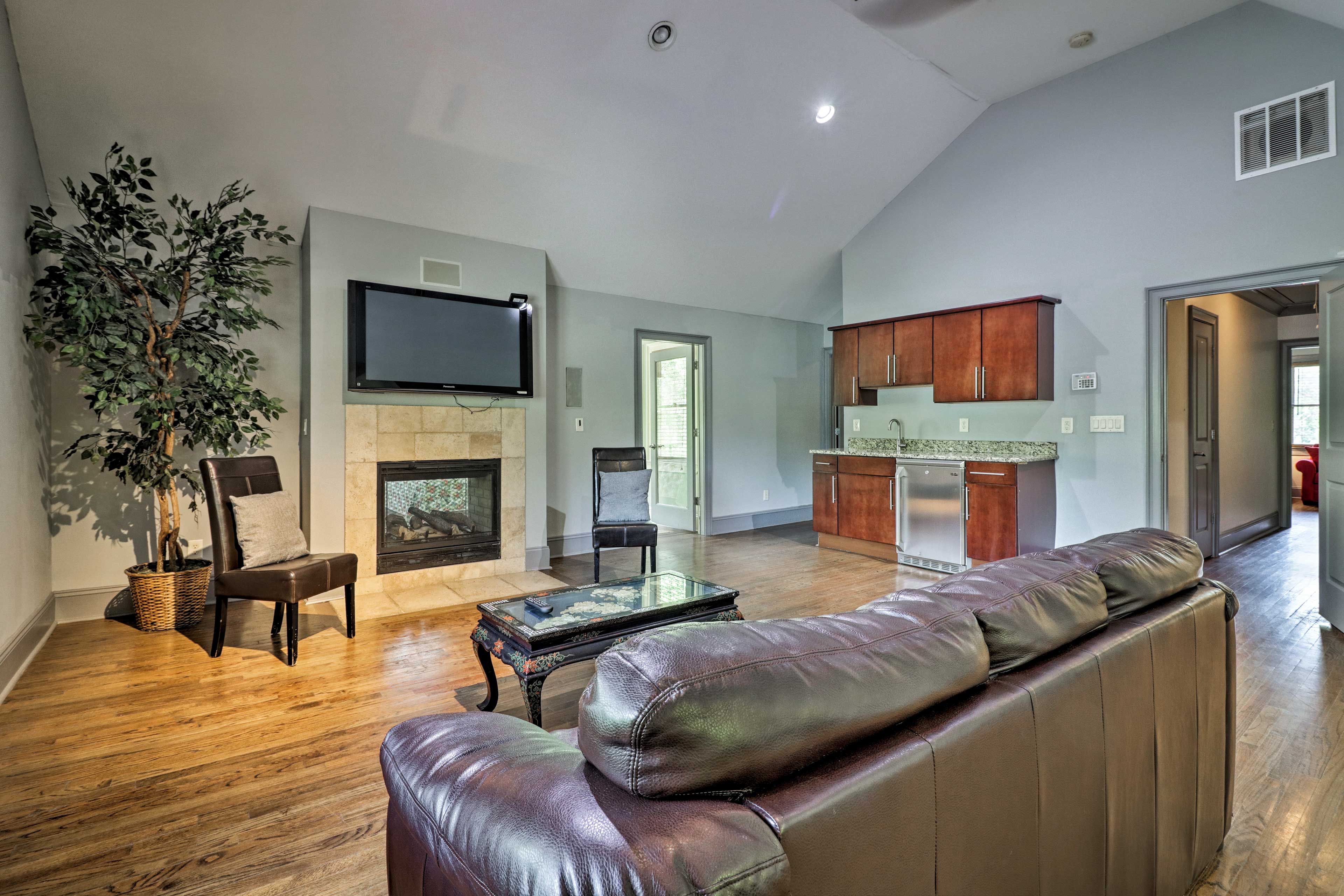 The bedroom features a flat-screen TV, gas fireplace, wet bar, and sunroom.