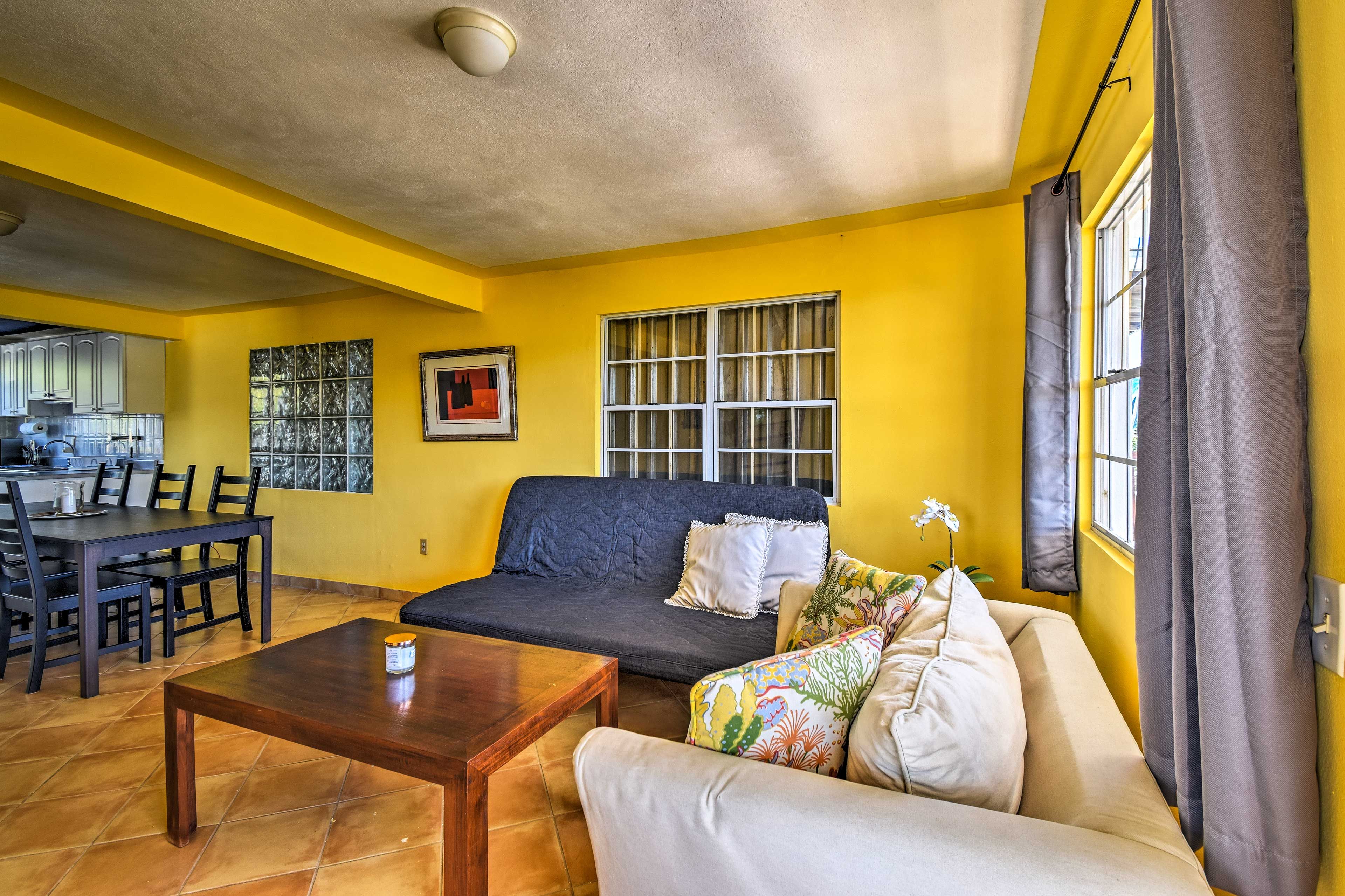 The living room includes a full futon and twin sleeper sofa.