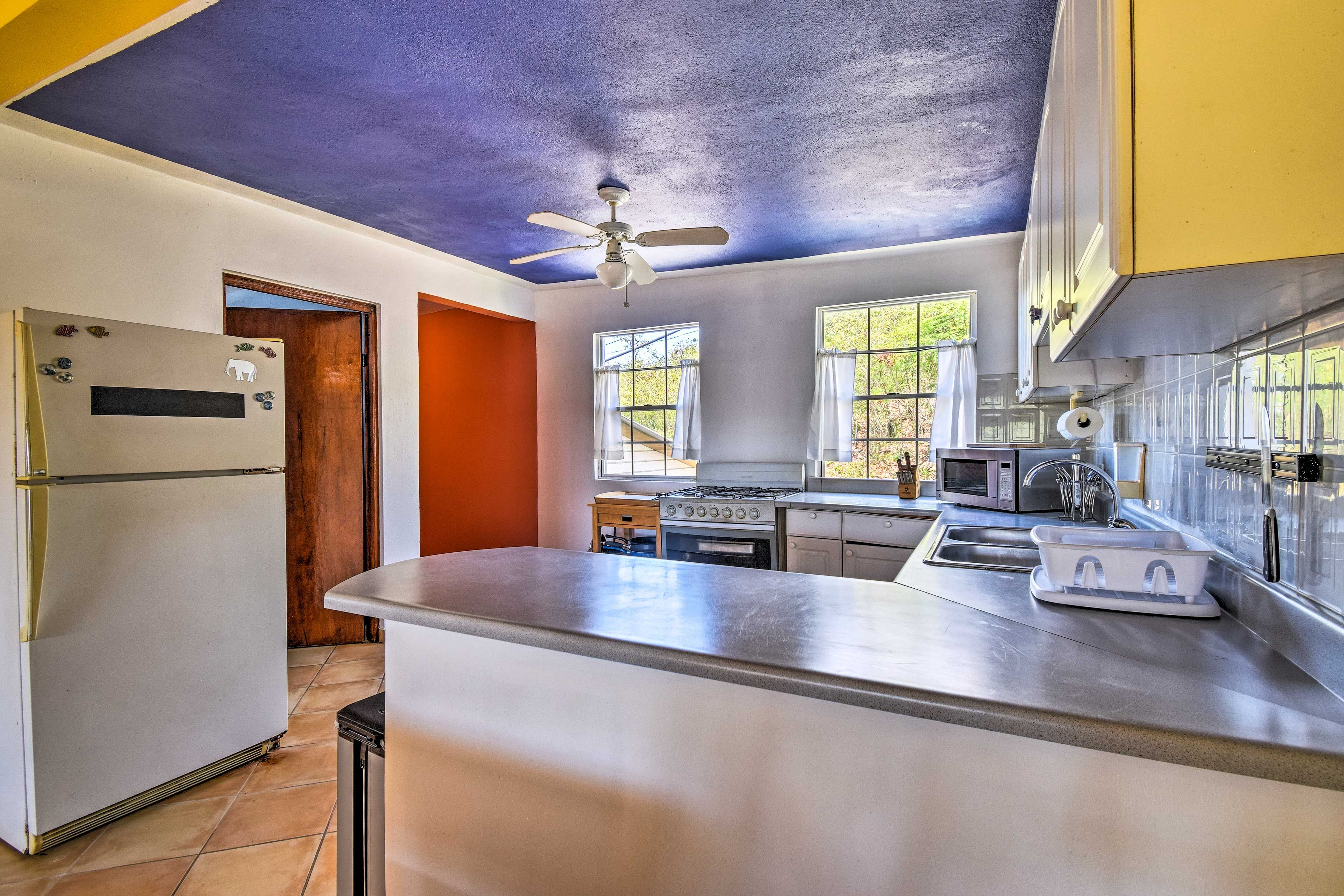 The spacious kitchen is fully equipped with several cooking necessities.