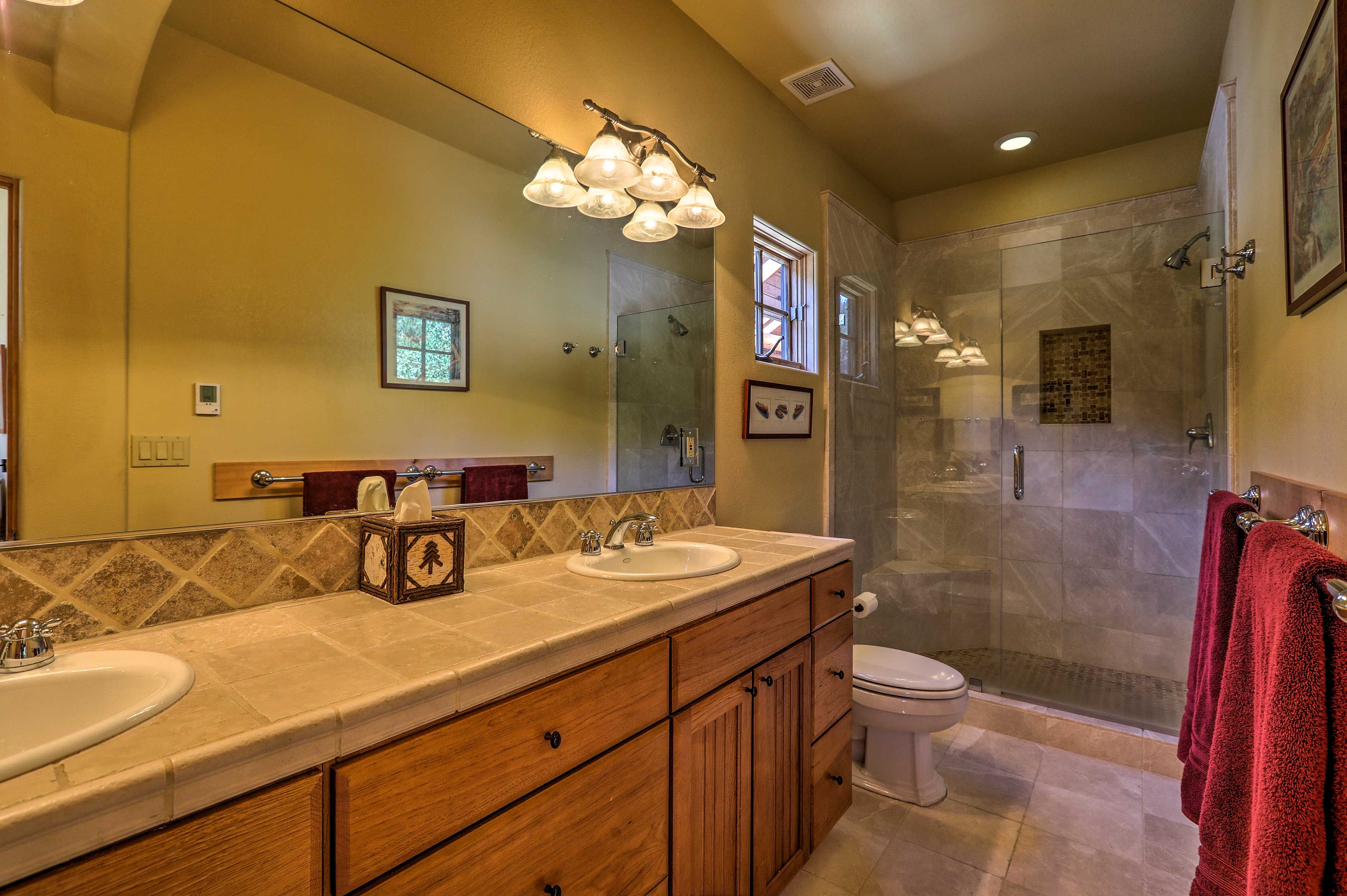 Utilize the ample counter space of this bathroom to get ready.