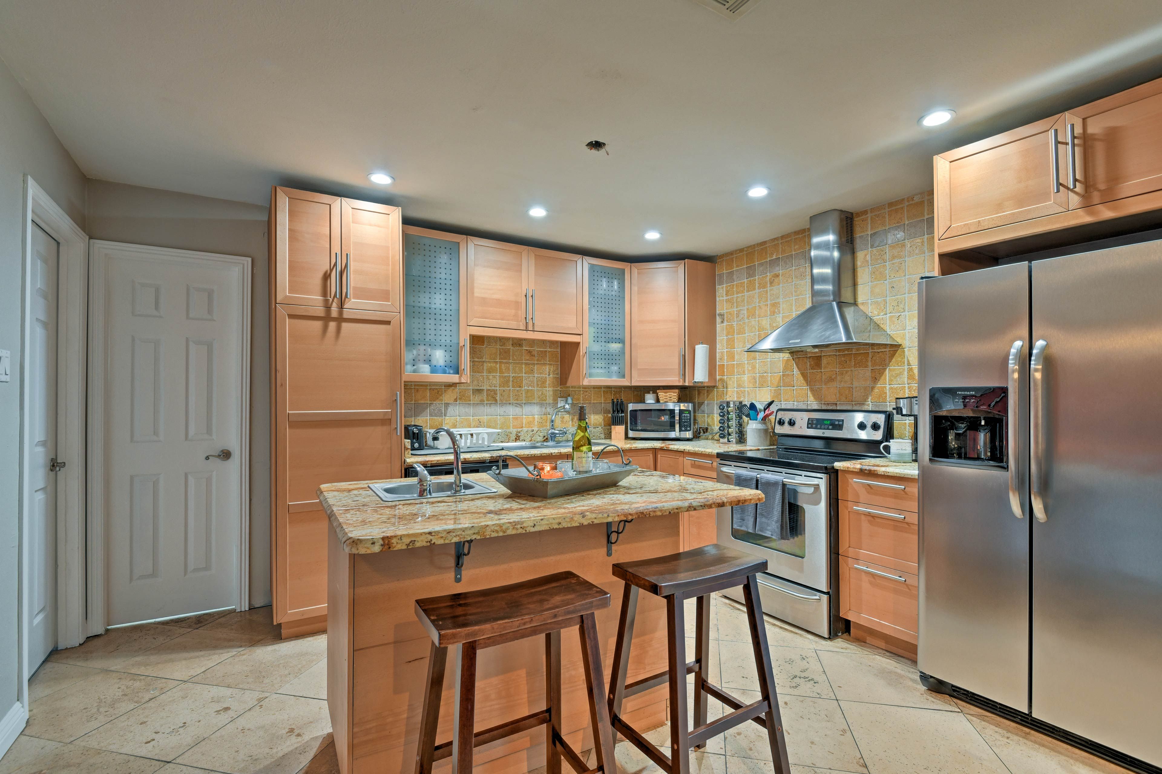 The fully equipped kitchen boasts stainless steel appliances.