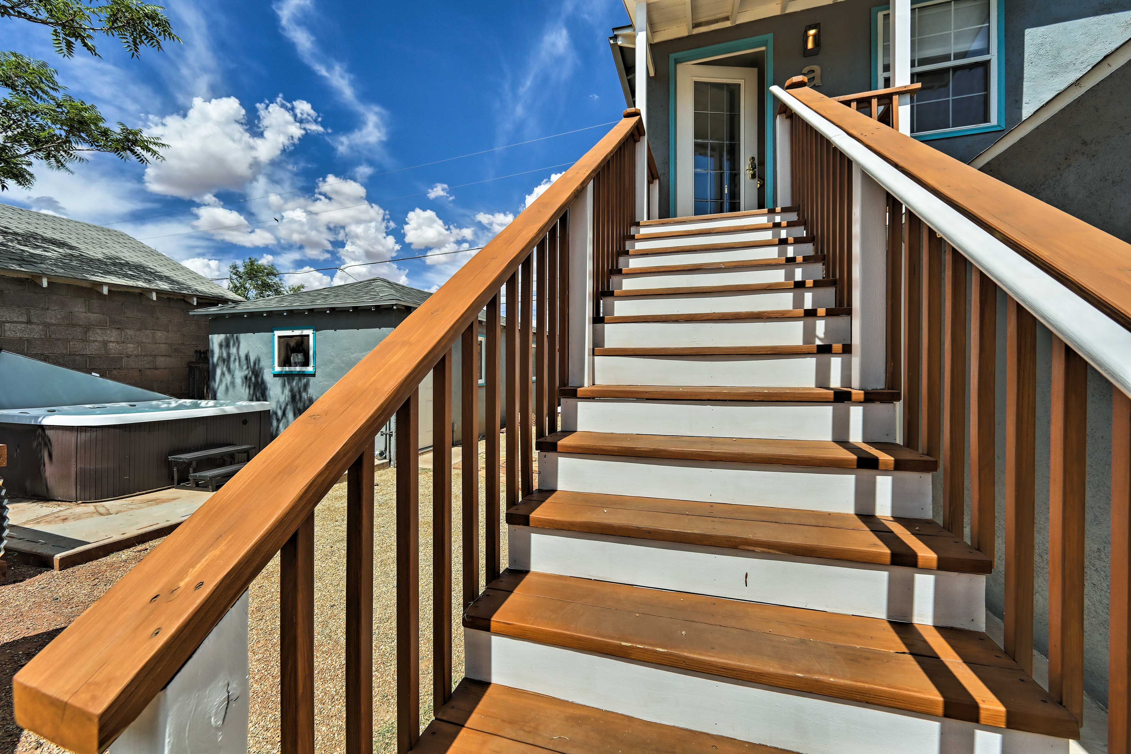 Walk down the stairs to the shared deck, grill, and Jacuzzi.