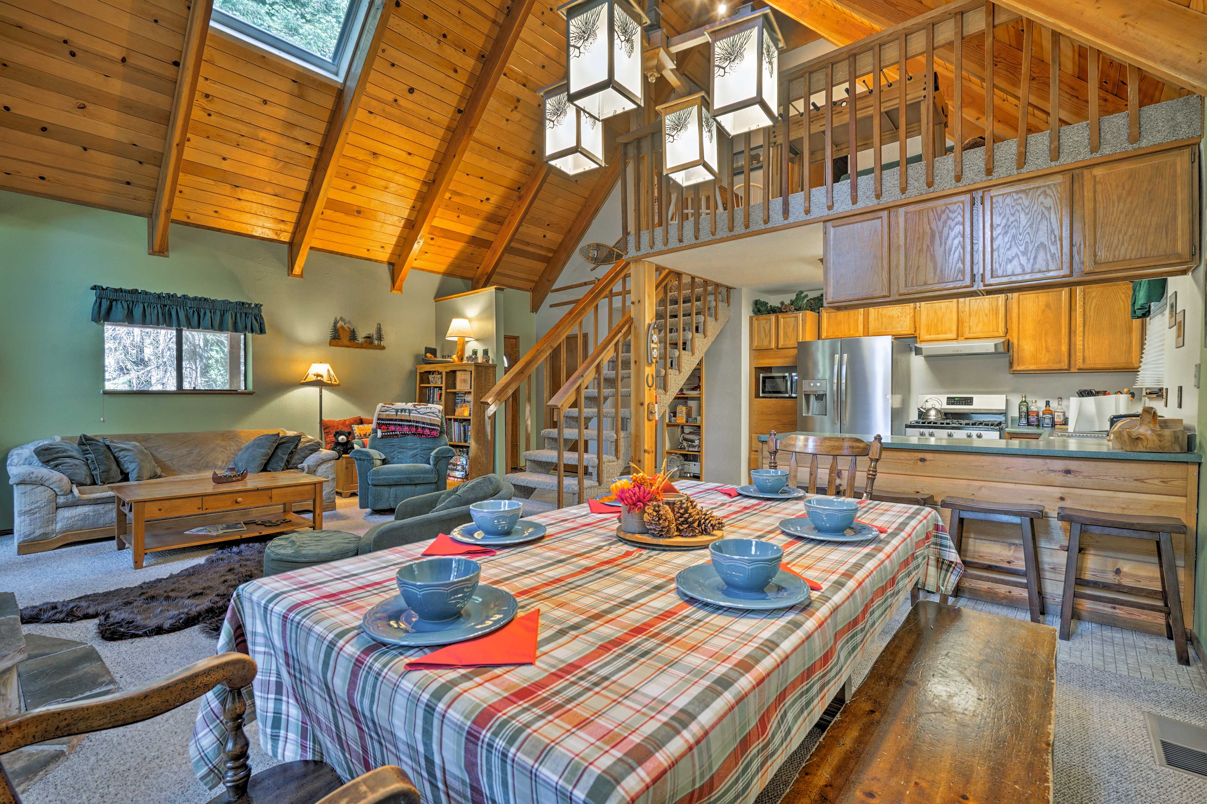 The open-concept dining area features a spacious table with benches.