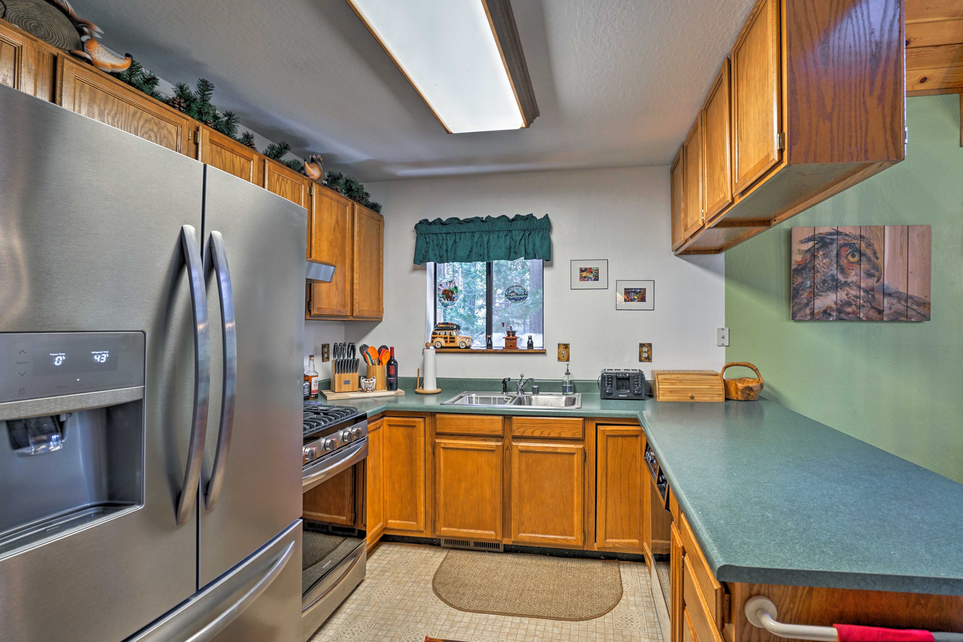 Stainless steel appliances & an extended kitchen bar enhance the space.