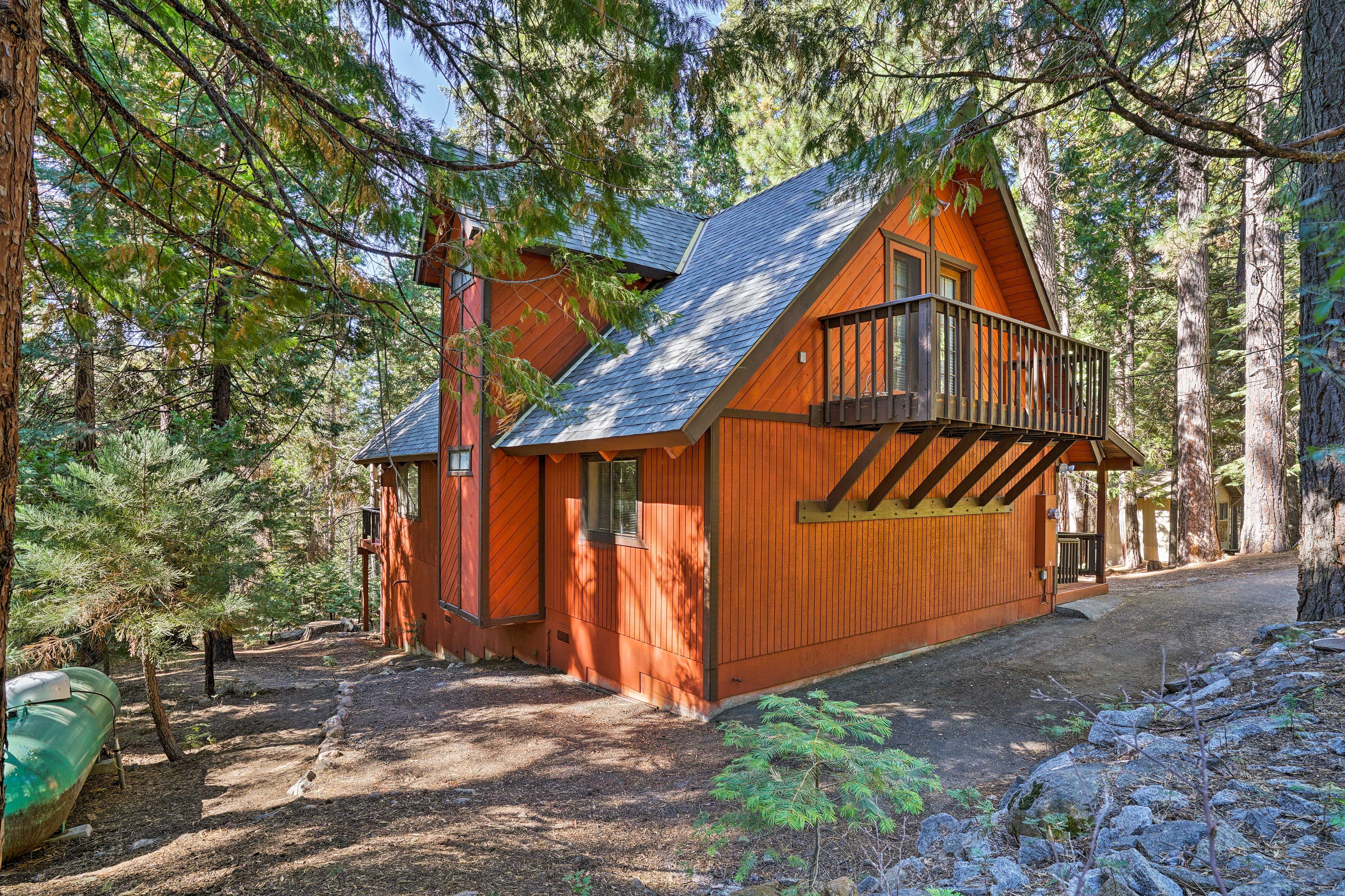The property features a chalet-style roof & traditional cabin wood paneling.