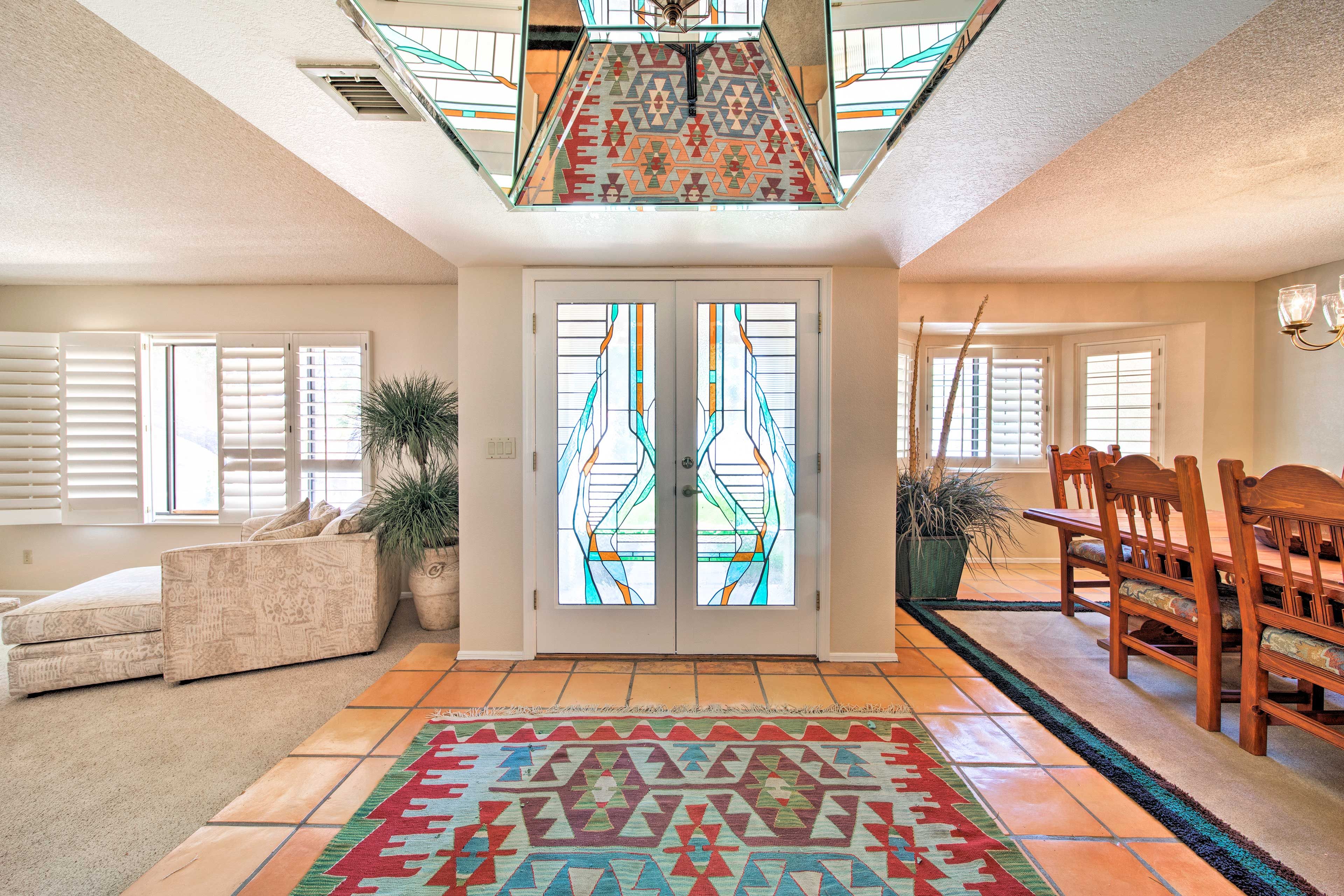A stunning stained glass French door highlights the entry way.