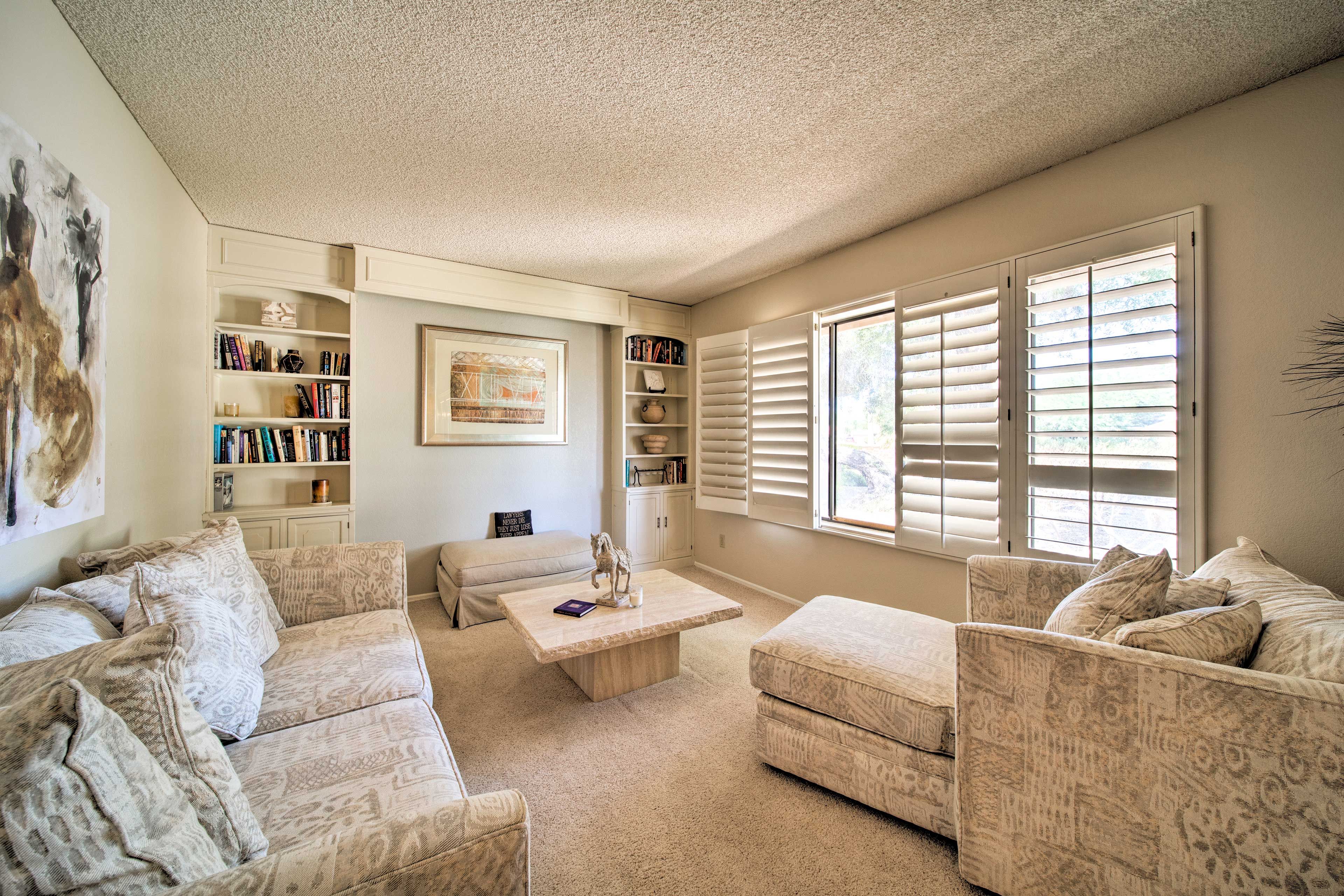 The front sitting room is stocked with books and plush furnishings.