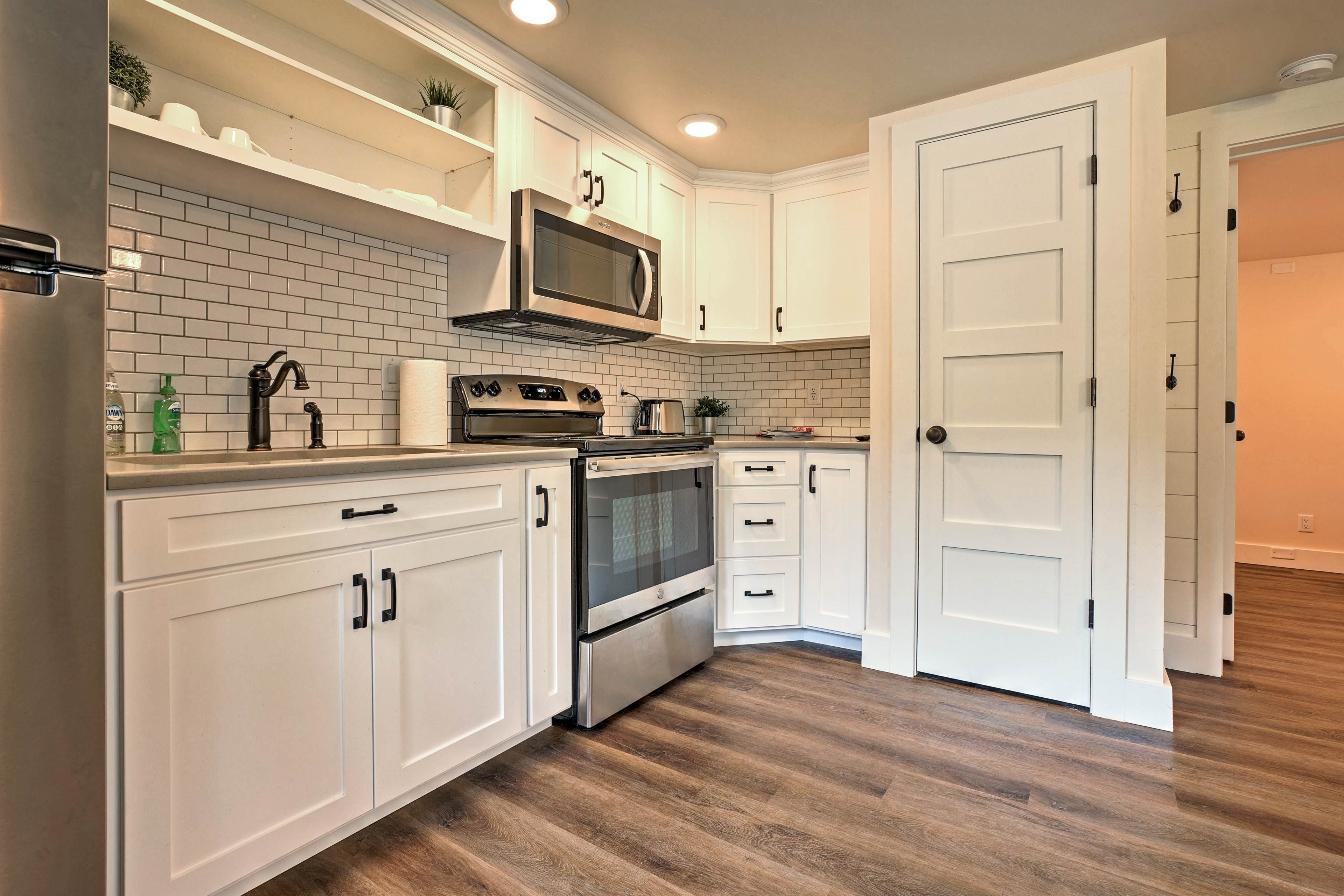 The well-equipped kitchen boasts stainless steel appliances and subway tile.