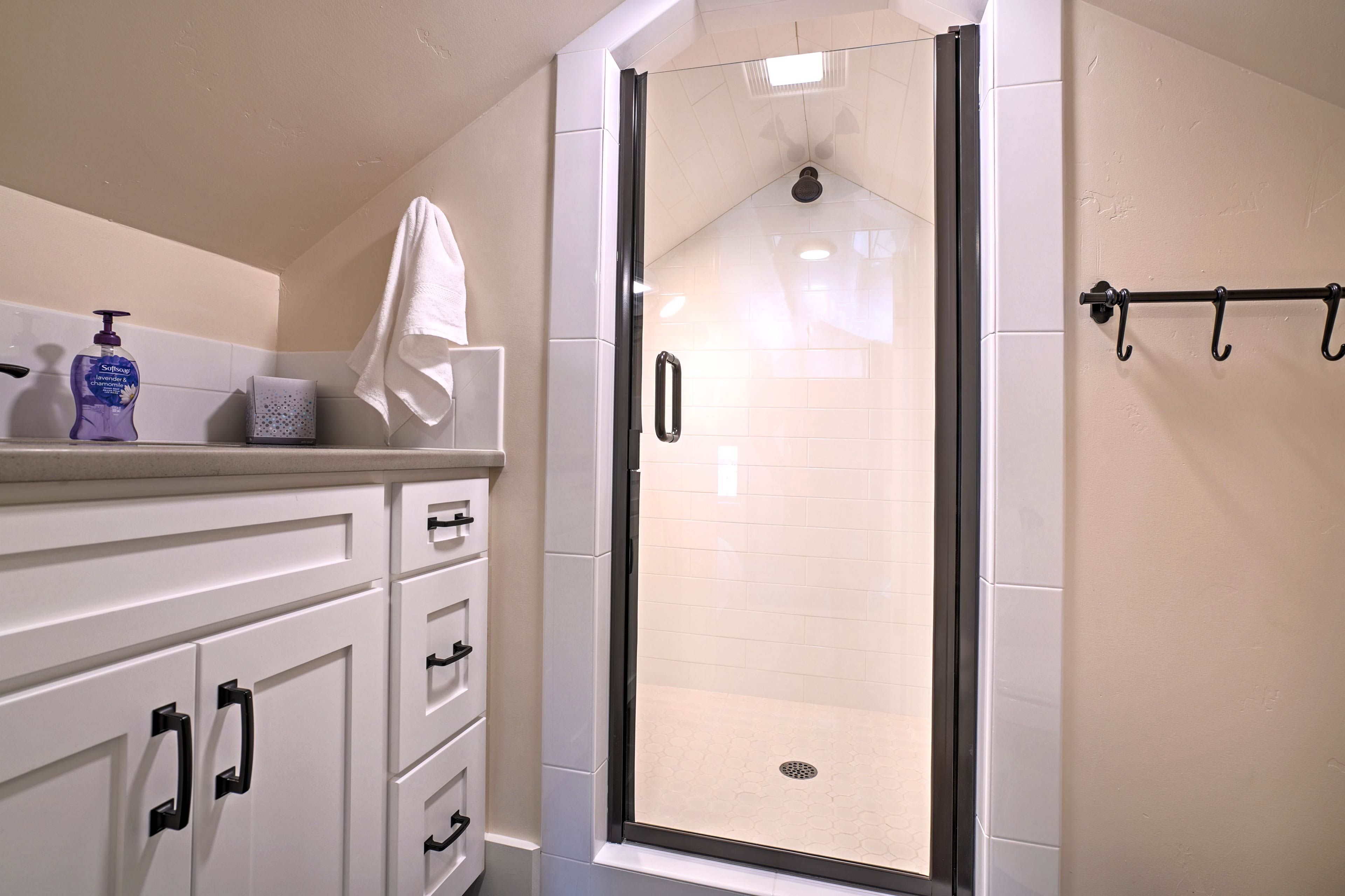 Upstairs in the loft area, this full bathroom boasts a spacious shower.