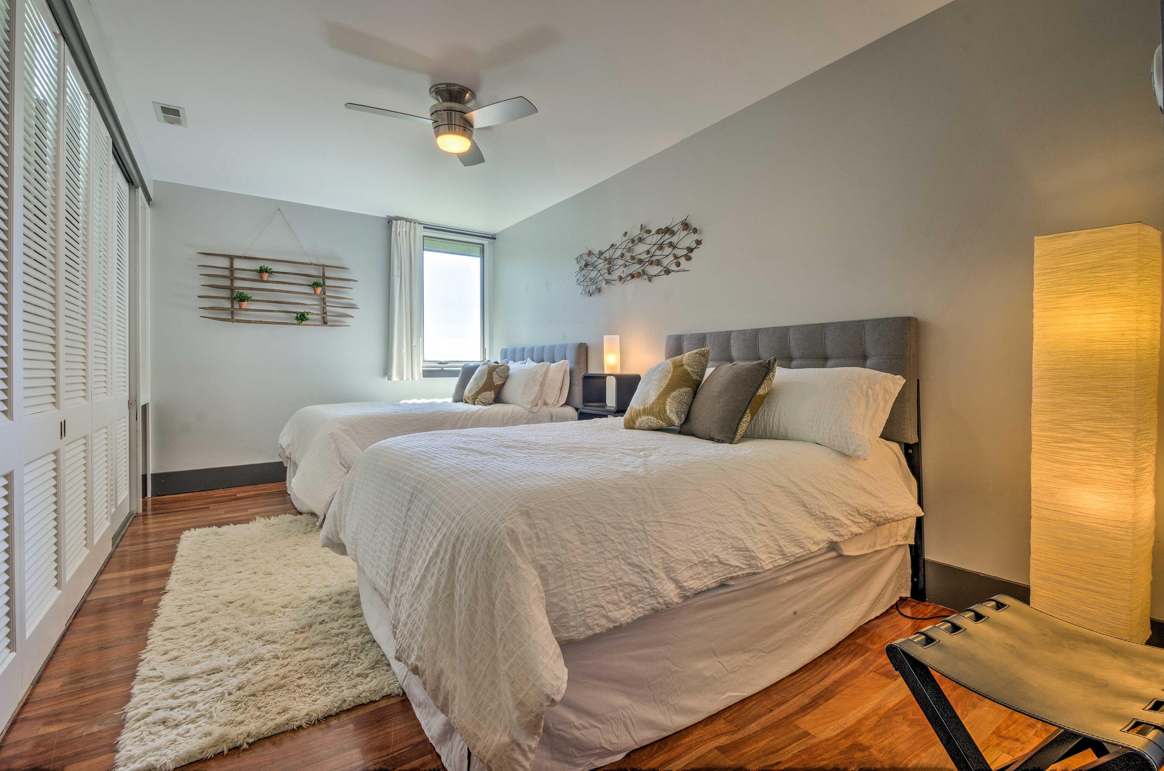This bedroom houses 2 queen-sized beds.