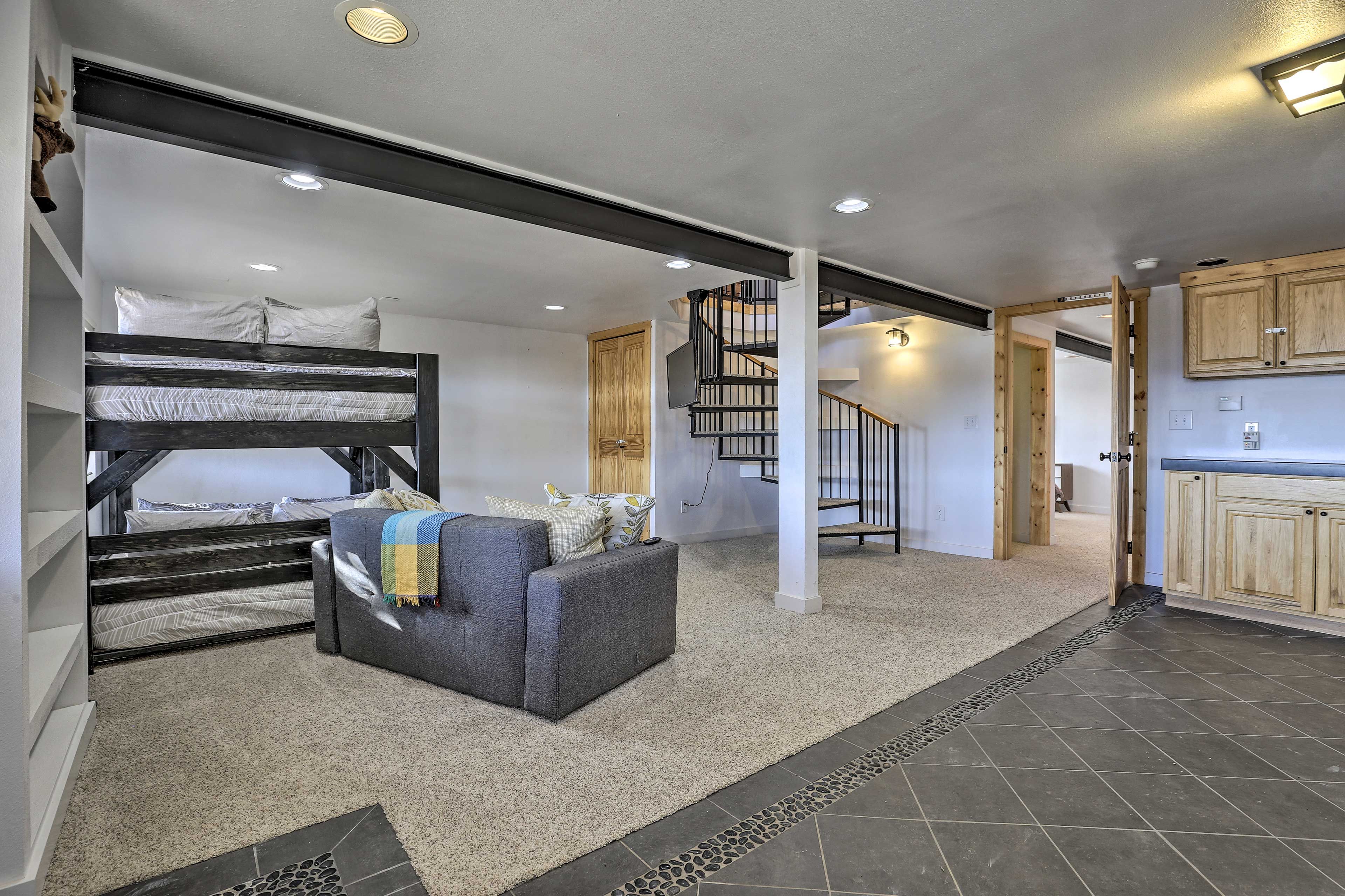 The lower level boasts an open layout and additional sleeping space.