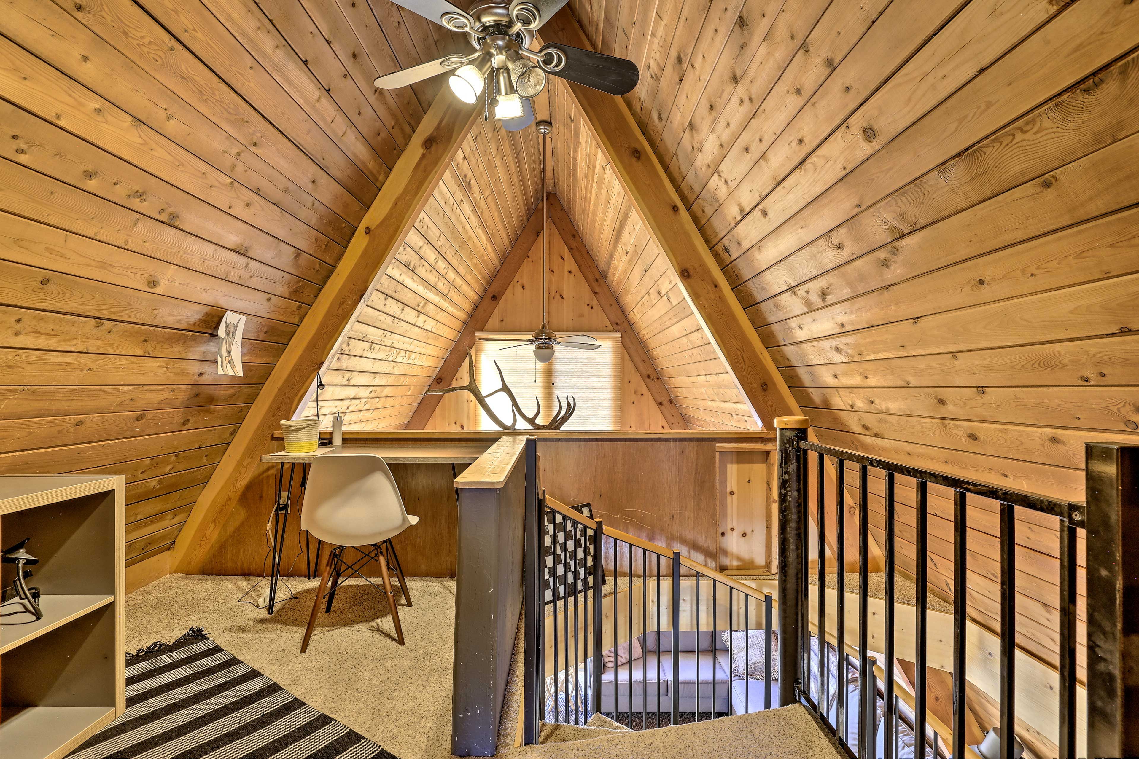 Head up the stairs to the lofted desk space.