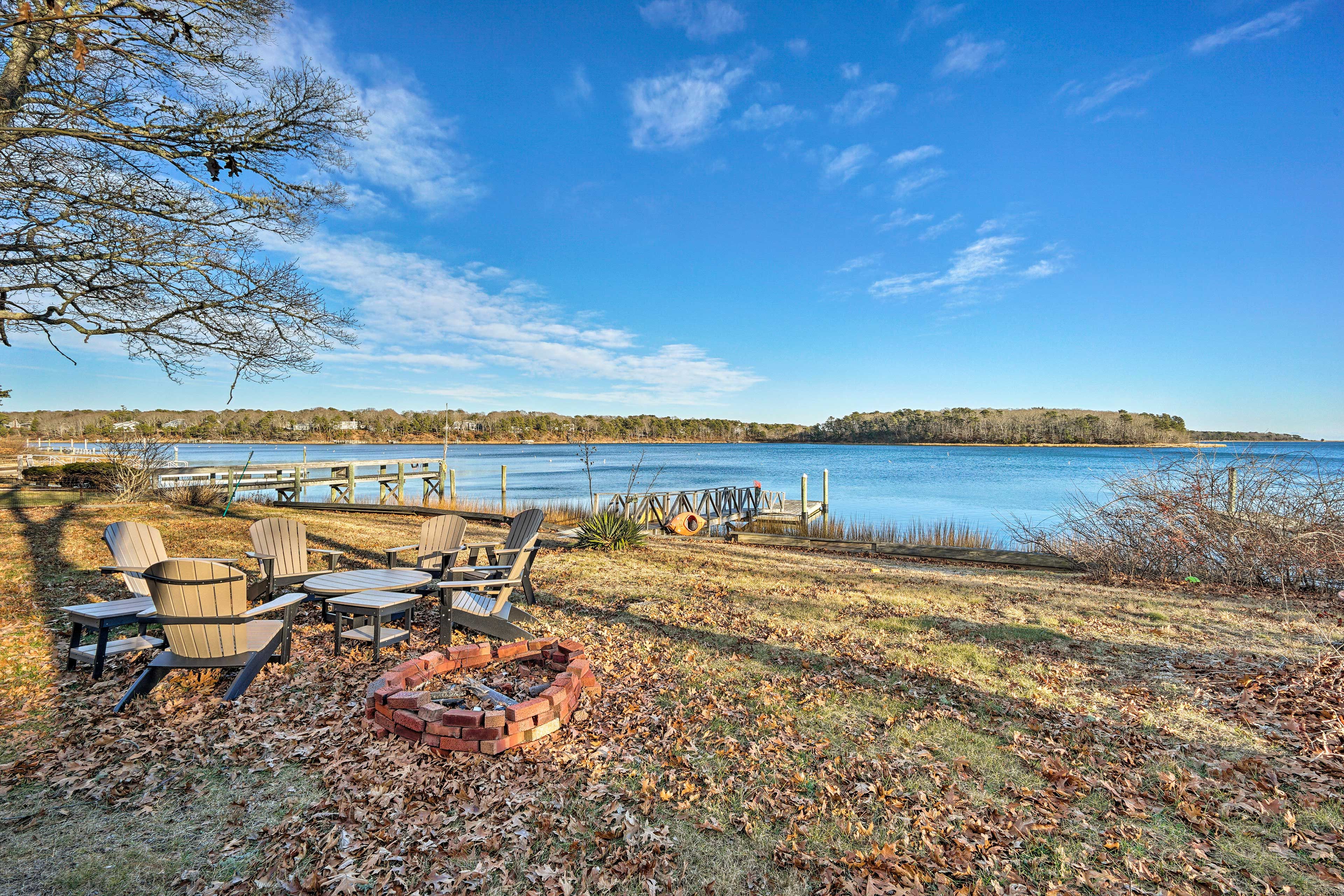 This home boasts a fire pit, deck, and boat dock!
