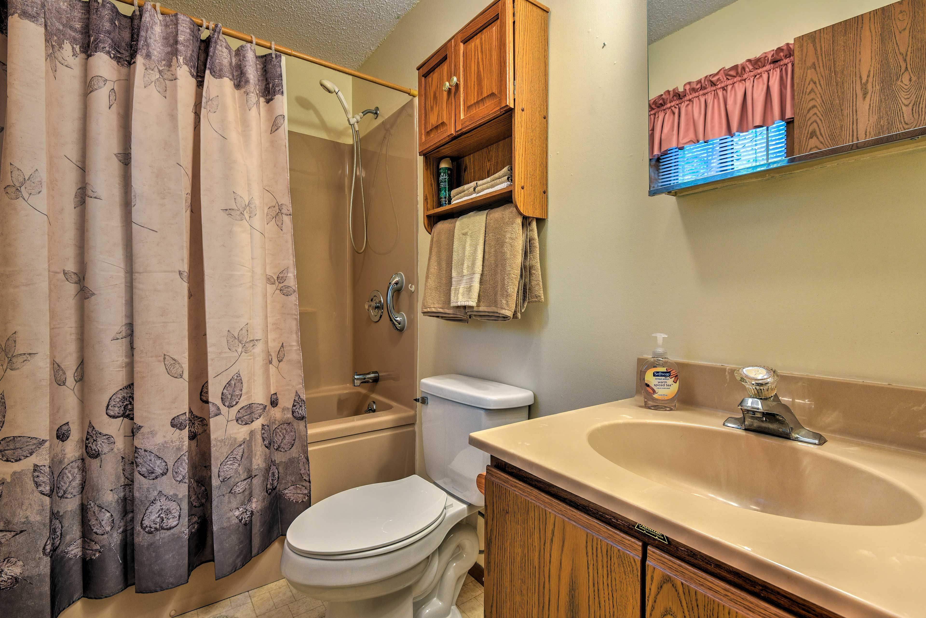 This en-suite bathroom includes a shower/tub combo.