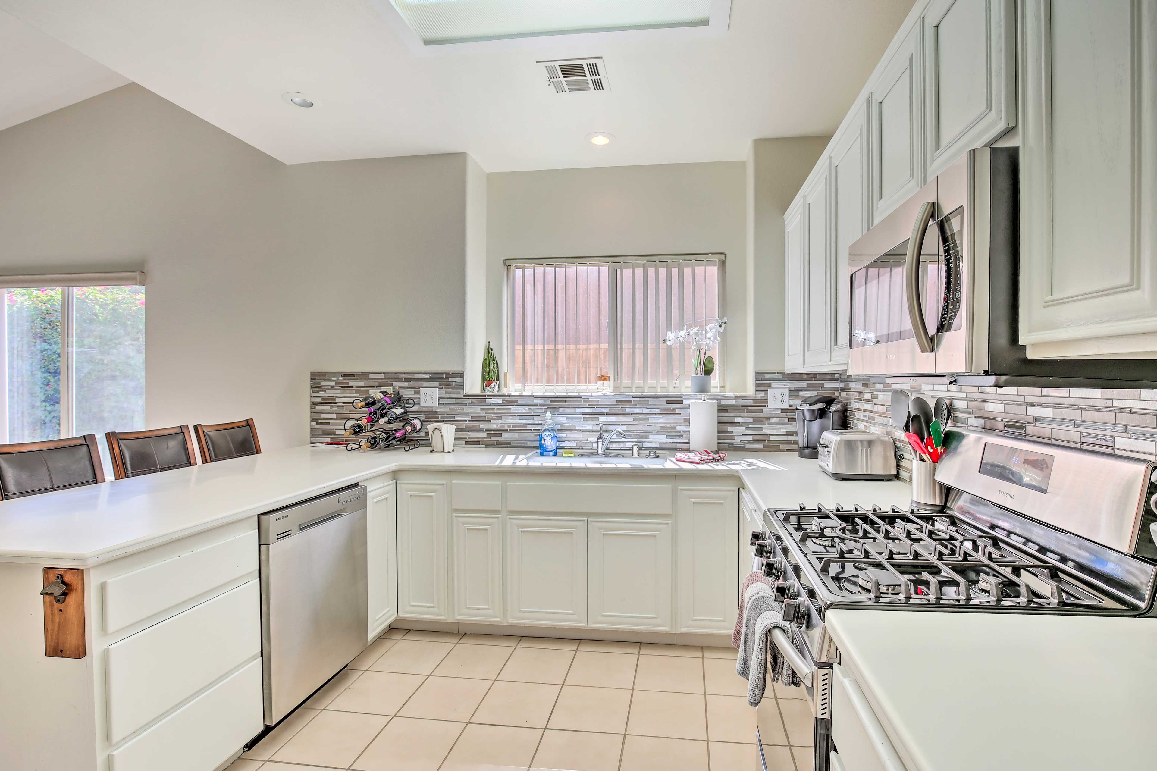 The fully equipped kitchen has stainless steel appliances.