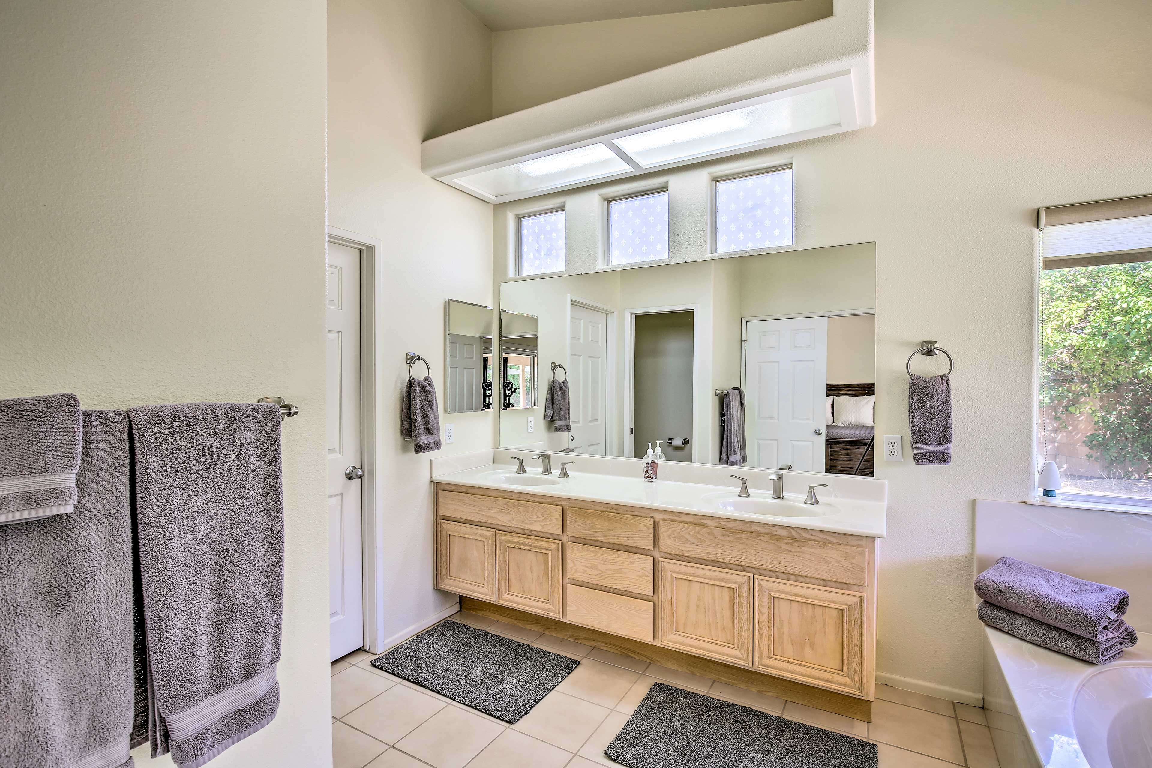 The spacious en-suite bathroom has a walk-in shower and tub.