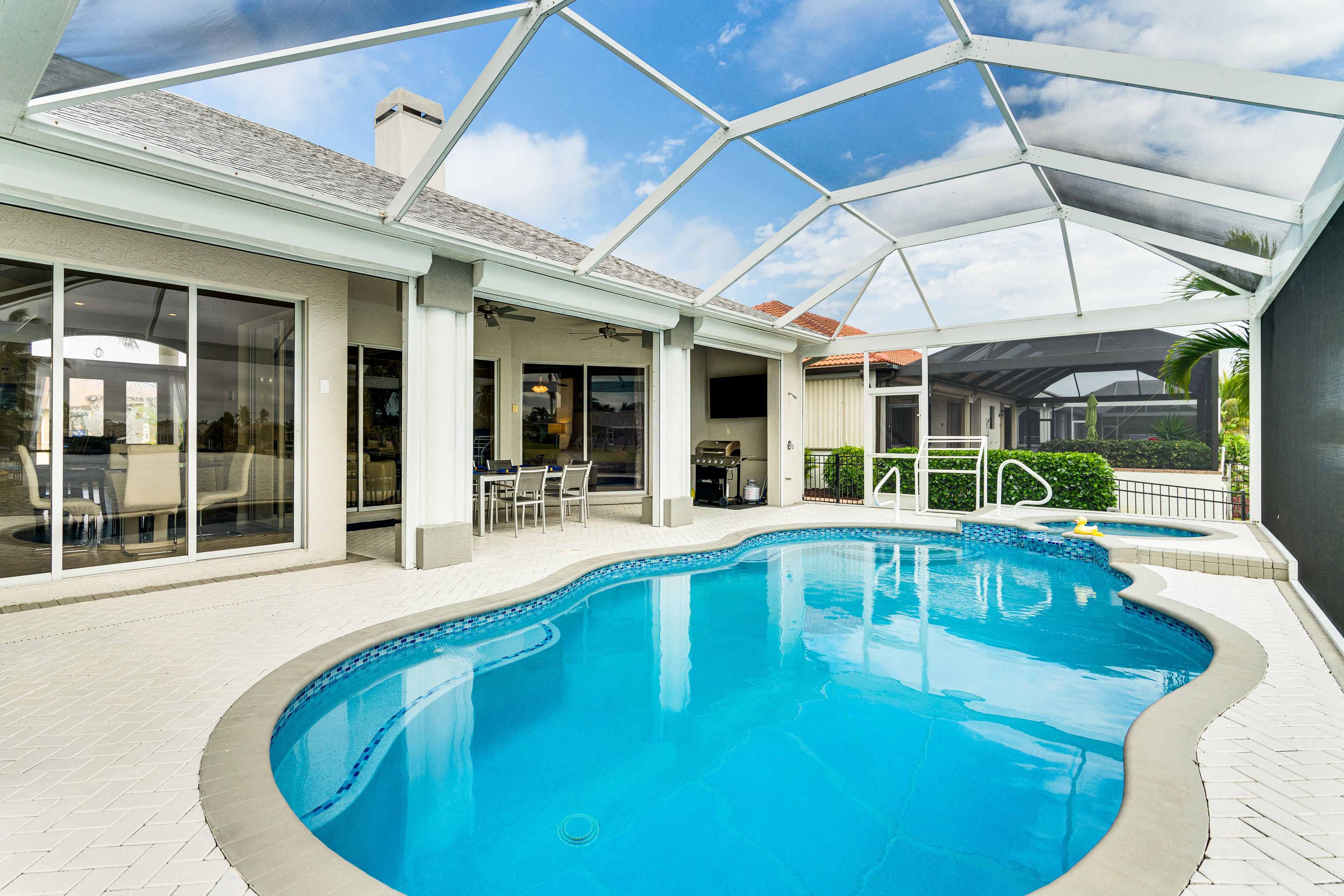 Screened Lanai | Heated Saltwater Pool & Hot Tub | Outdoor Dining Area