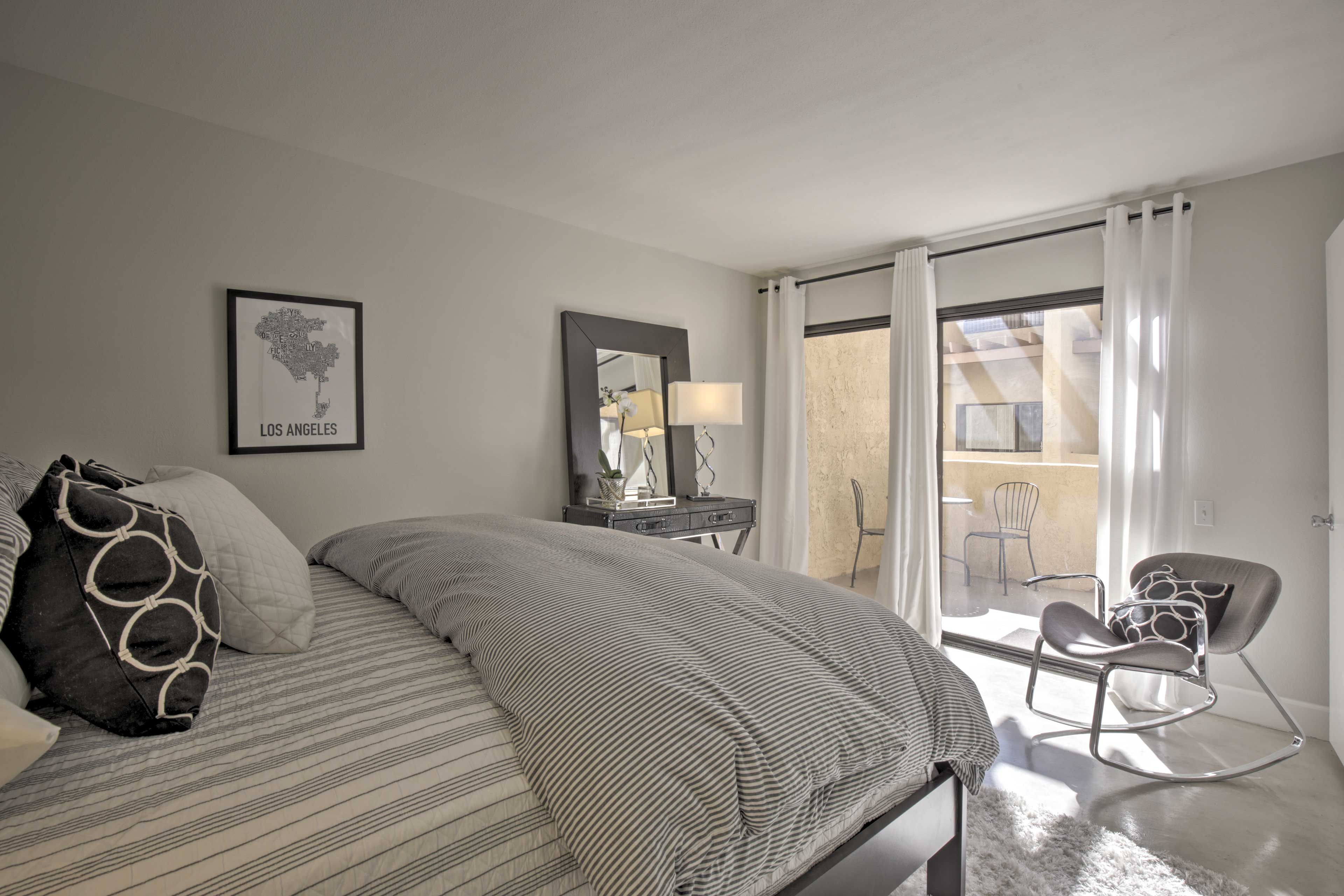 The queen bed faces a private balcony.