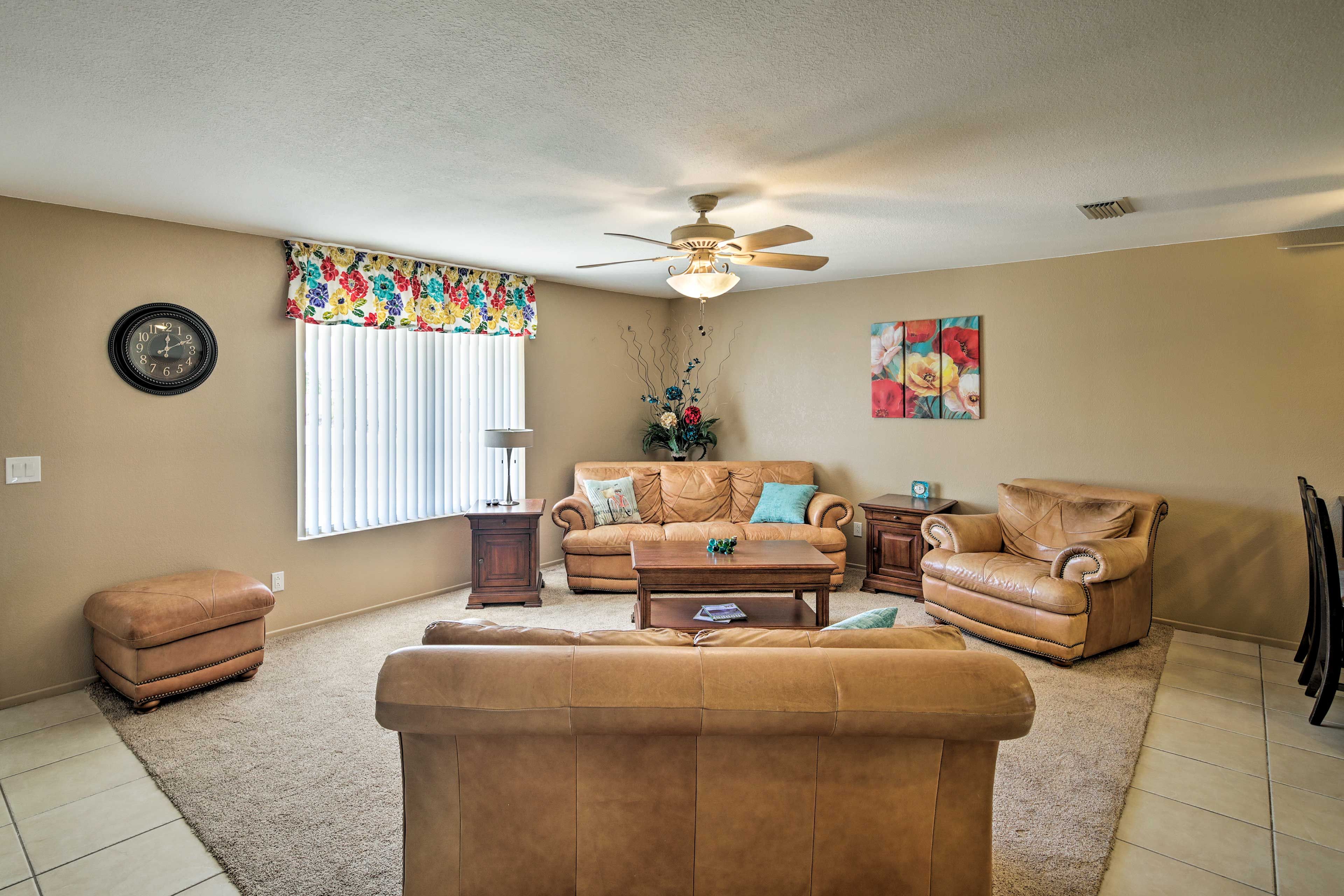 The interior of this home has comfortable furniture and ceiling fans throughout.