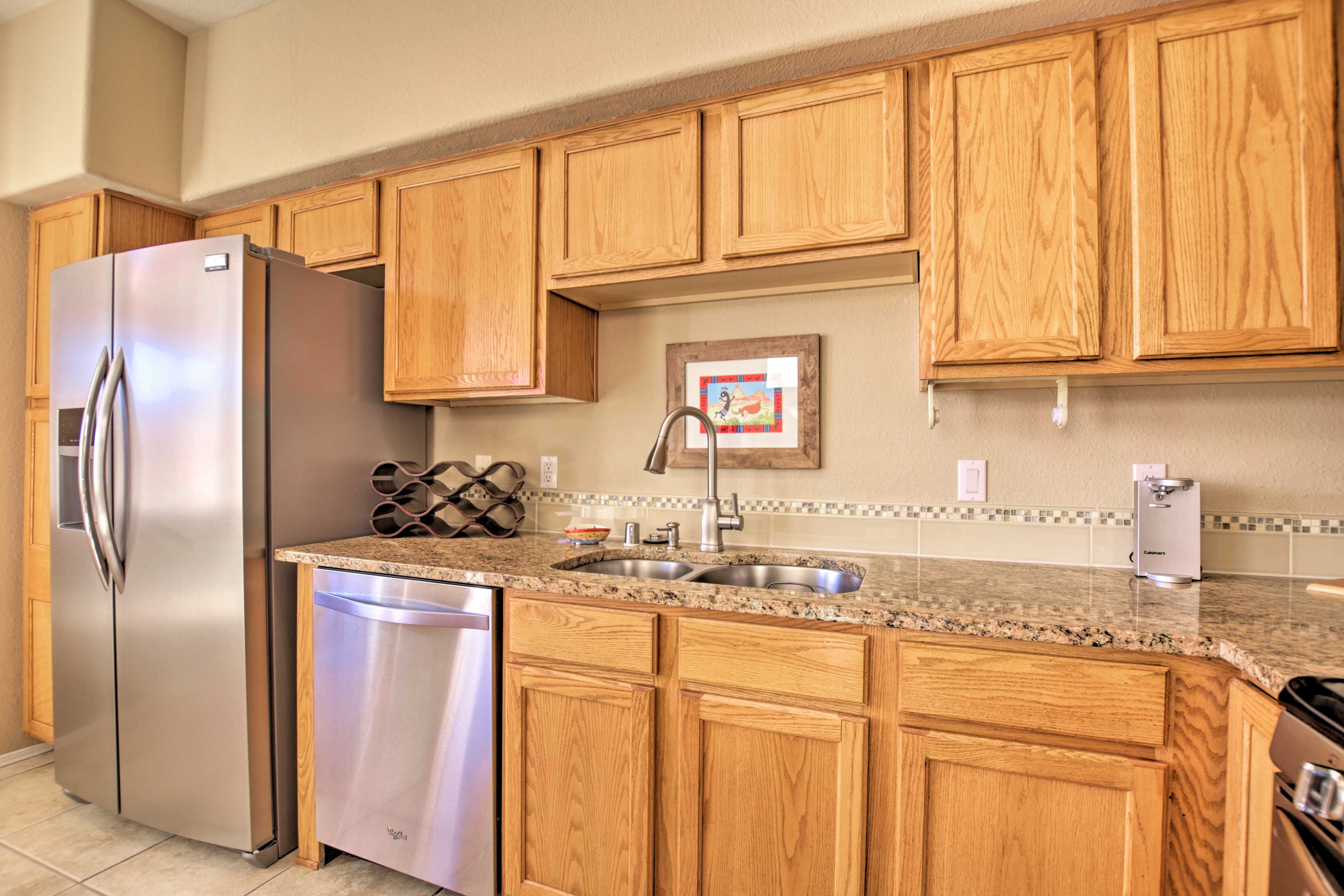 Sleek stainless steel appliances enhance the stylish kitchen.