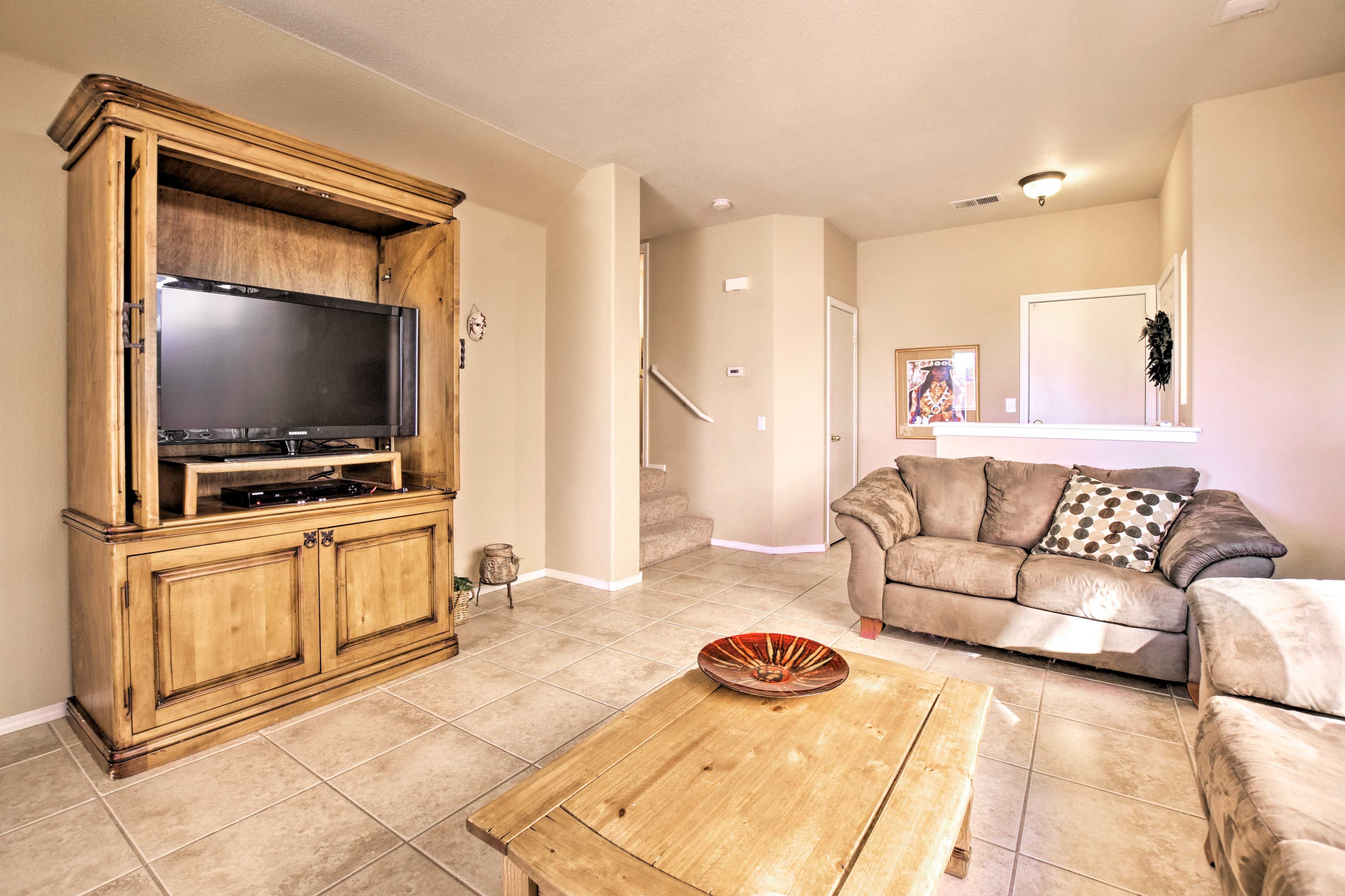 The flat-screen TV includes streaming capabilities & a DVD player.