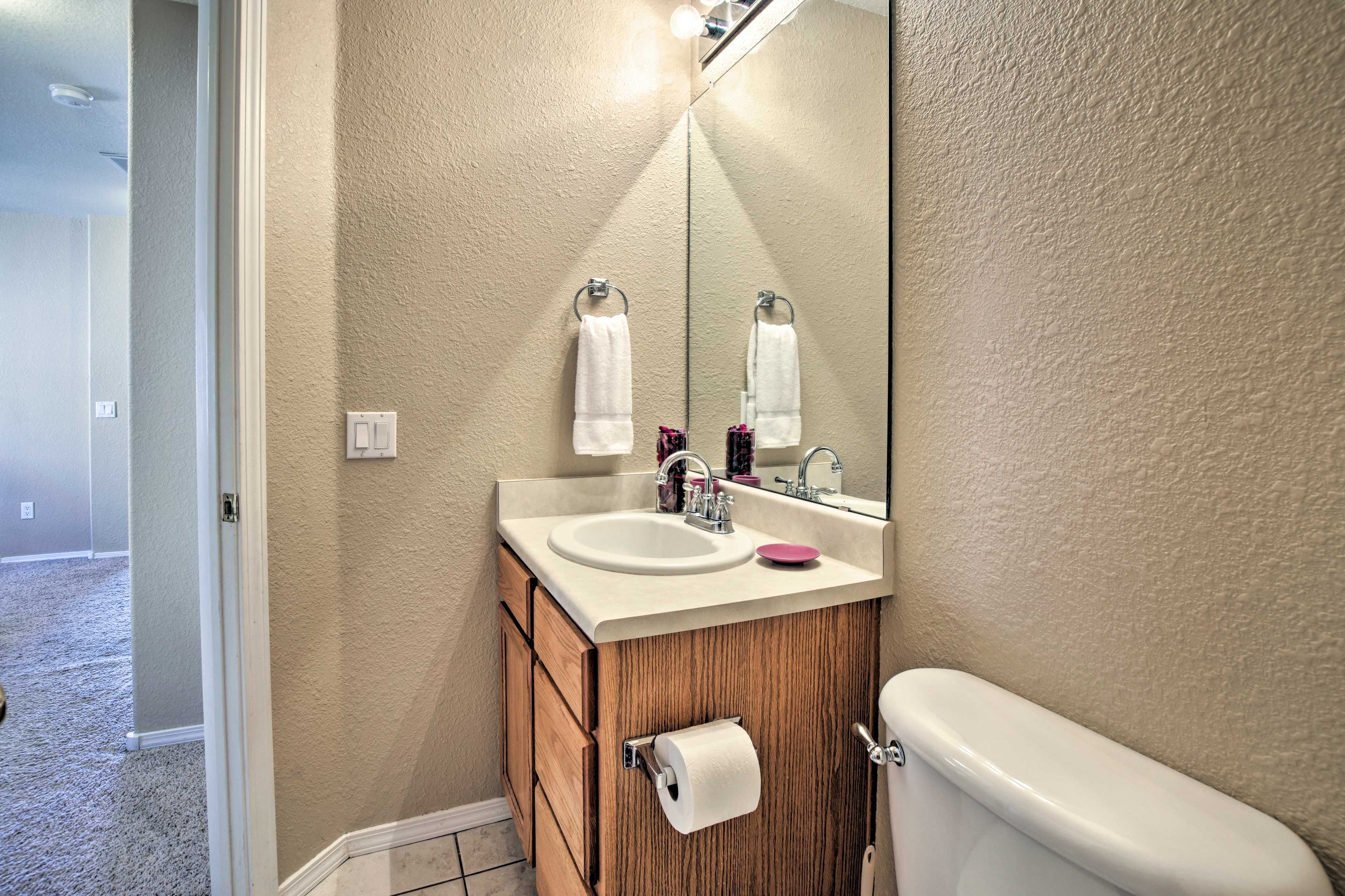 Freshen up for the day at this clean vanity.