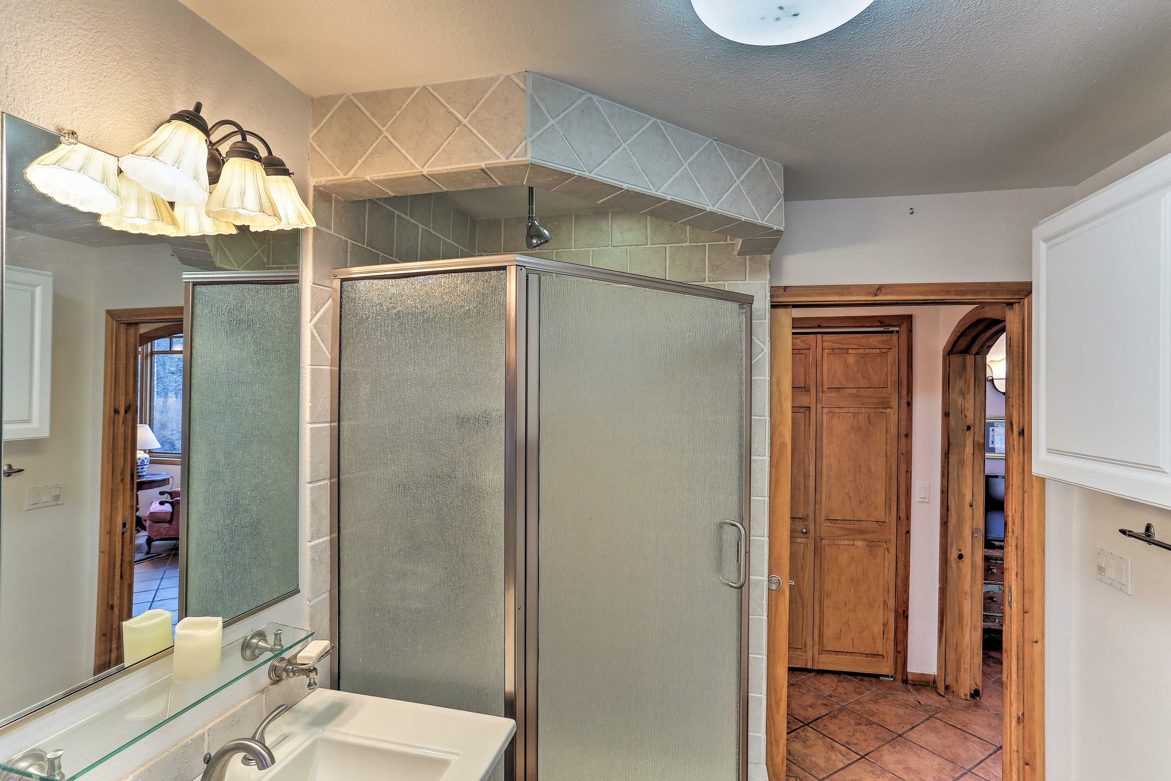Rinse off in the walk-in shower with frosty glass doors.