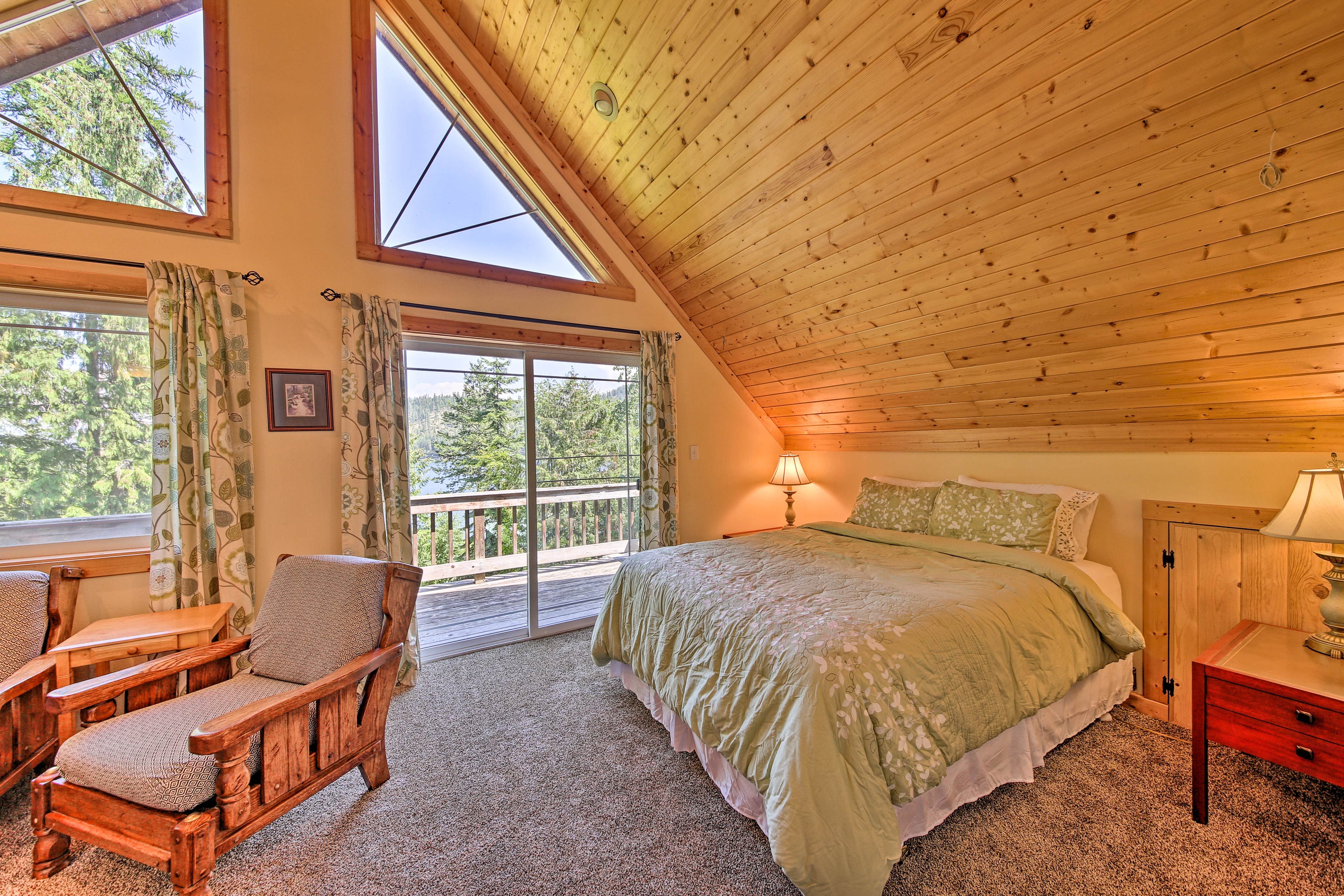 The upstairs bedroom boasts a queen bed and balcony access.