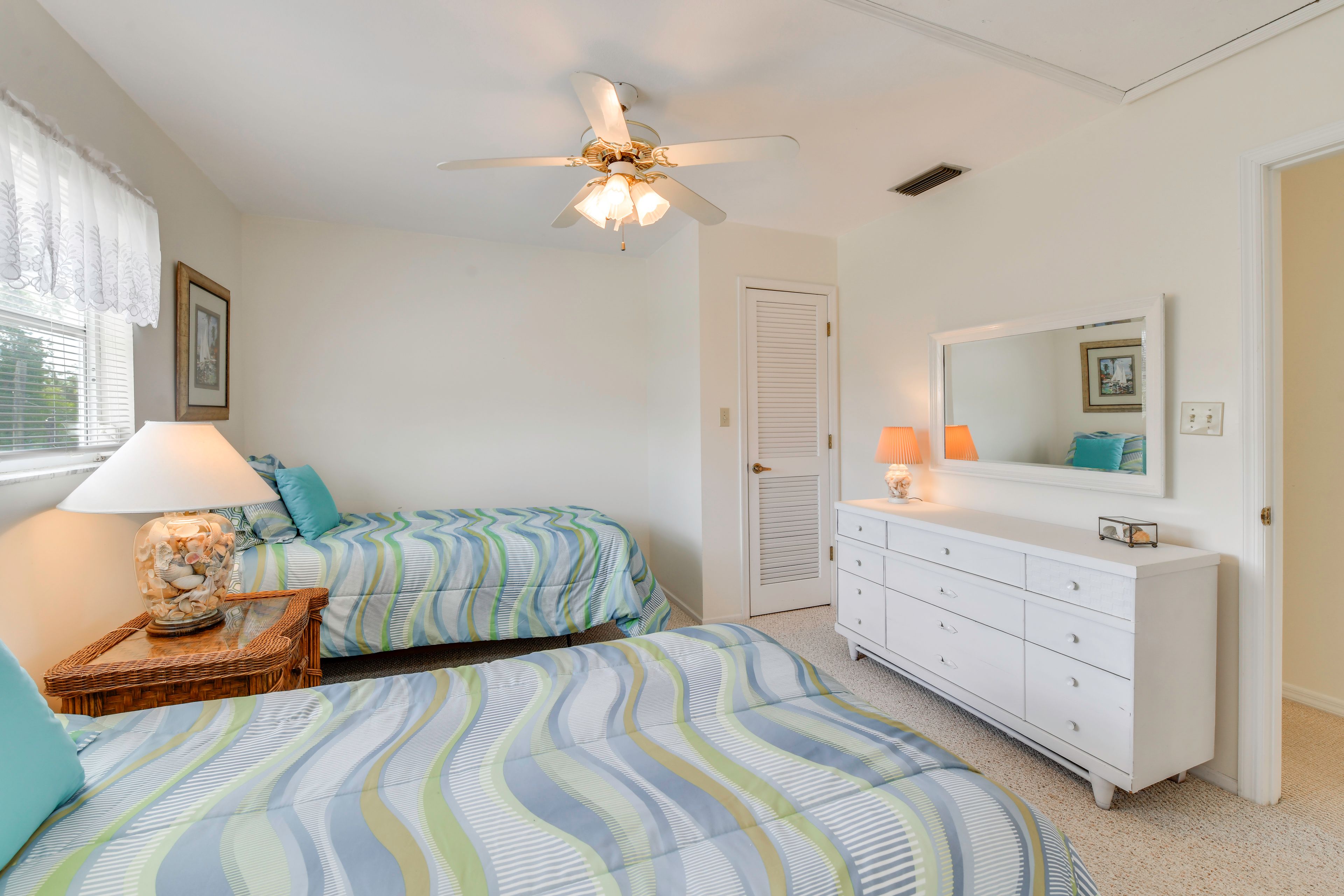 Two can share this first guest bedroom with twin-sized beds.