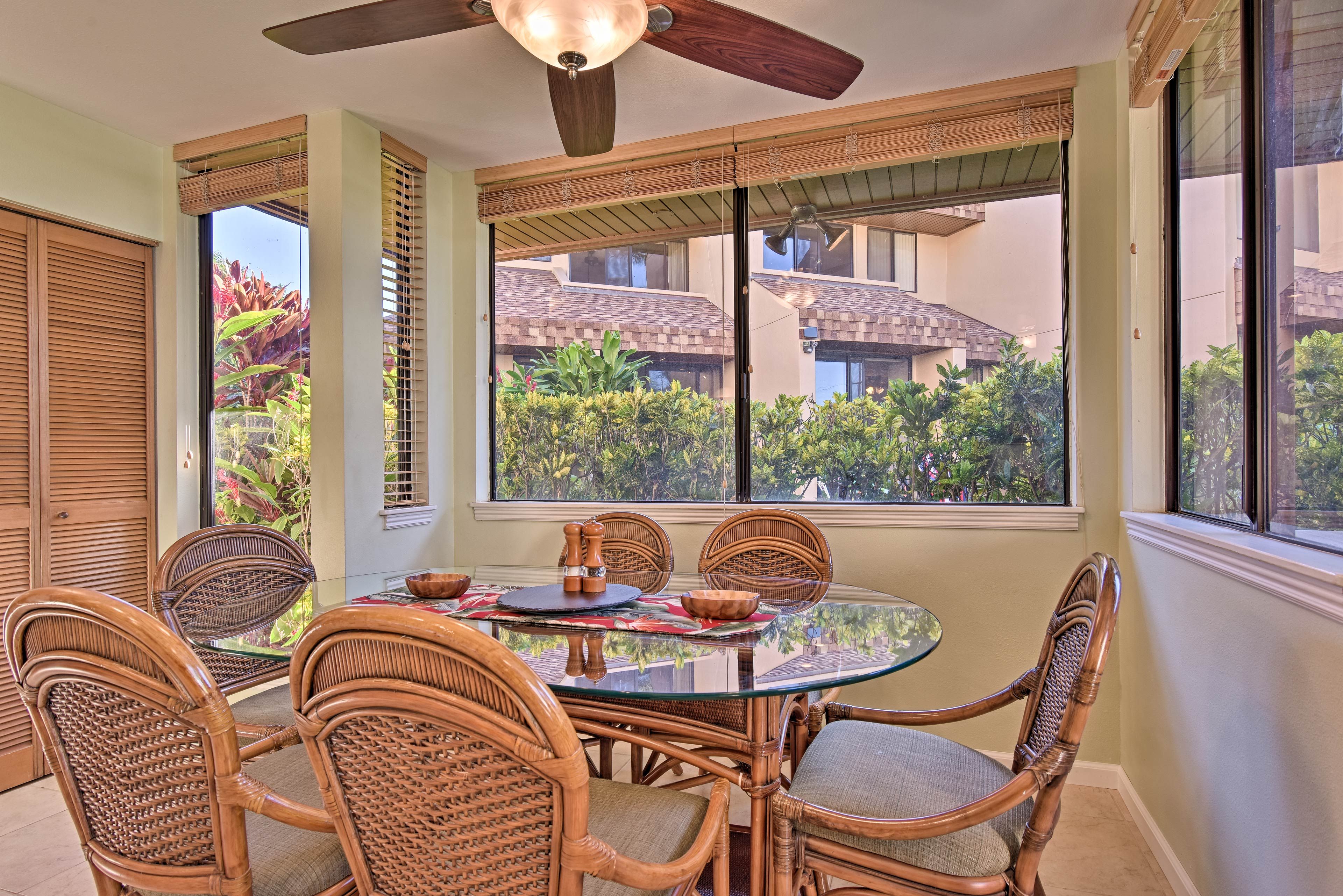 Tropical landscaping can be seen through the windows.