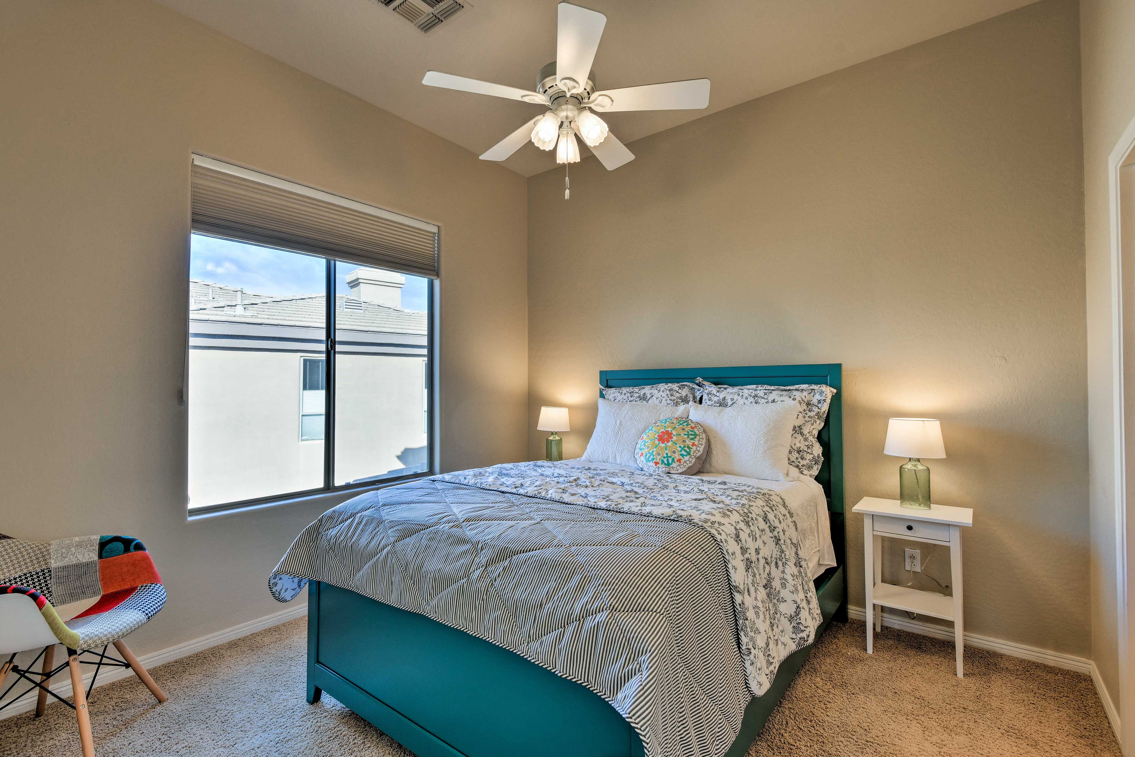 The second bedroom features a queen-sized bed and plenty of natural light.