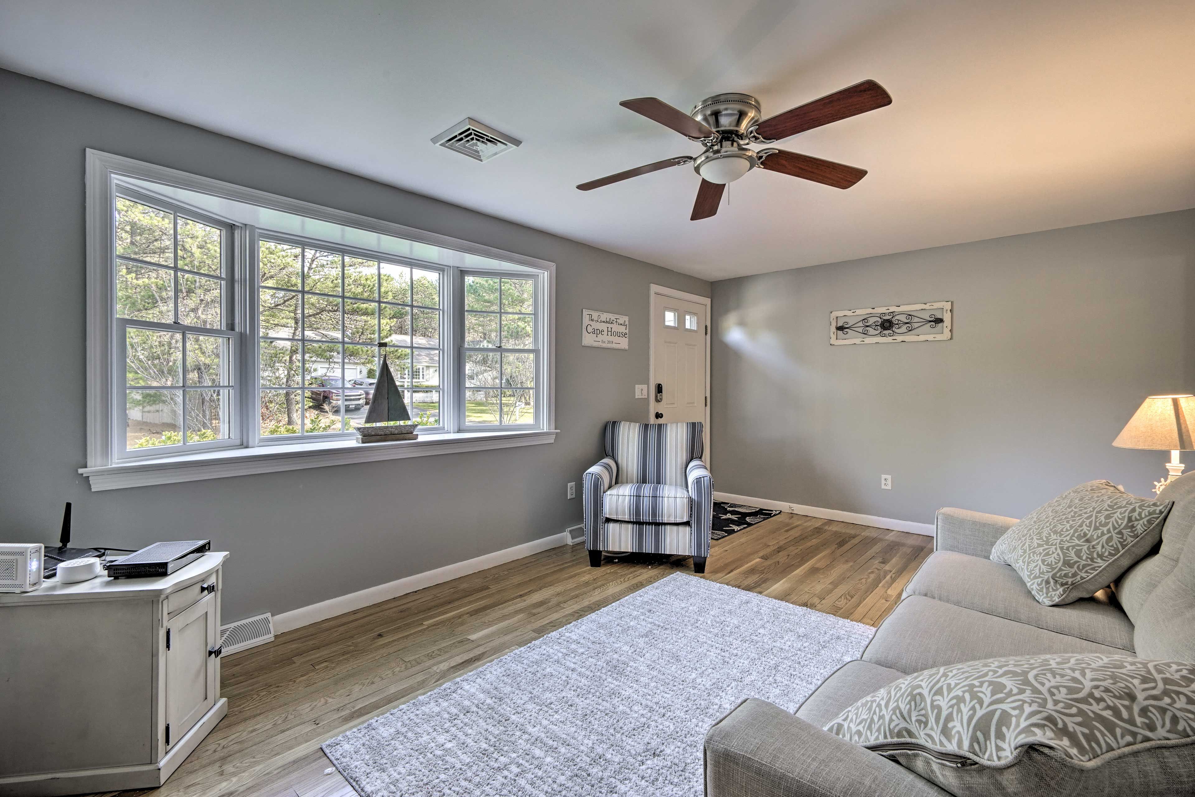 A large bay window fills the living area with warm natural lighting.