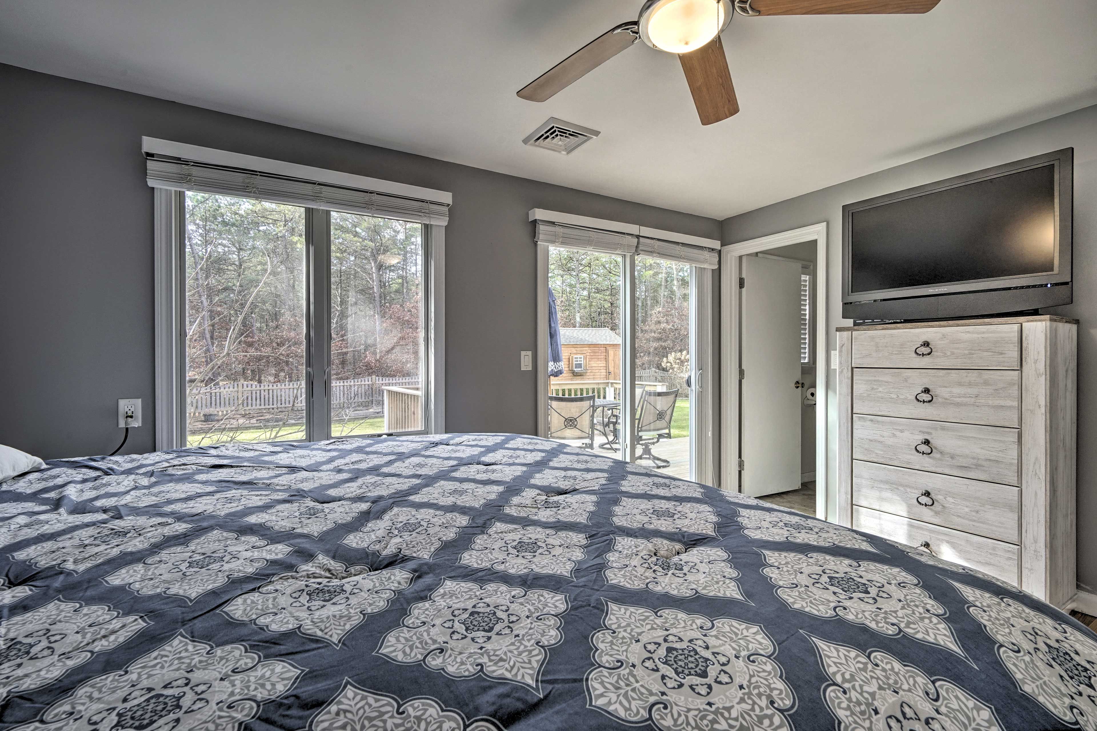 Two sets of sliders connect the bedroom suite to the backyard.